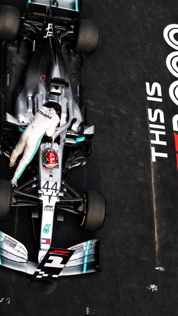 750x1334 Download Lewis Hamilton Gearing Up Inside His Racing Cockpit Wallpaper