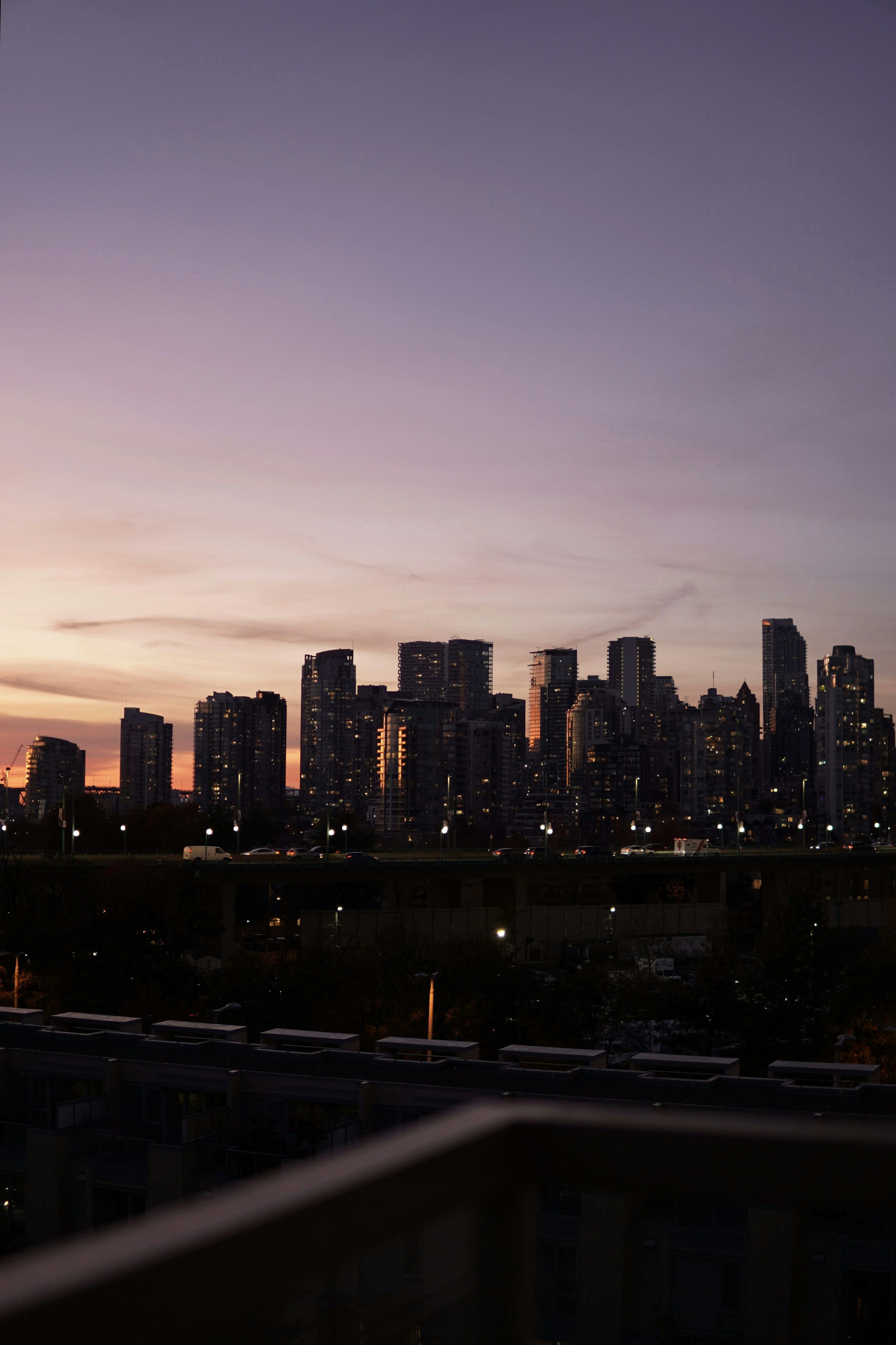 3000x4501 A view of a city at night from a balcony photo