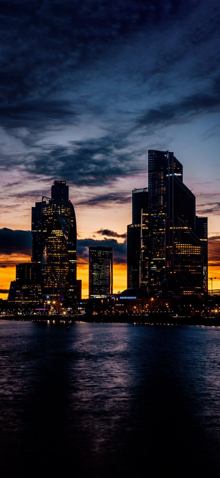 720x1560 Dark City Buildings In Front Of A Lake 4K Phone Wallpaper