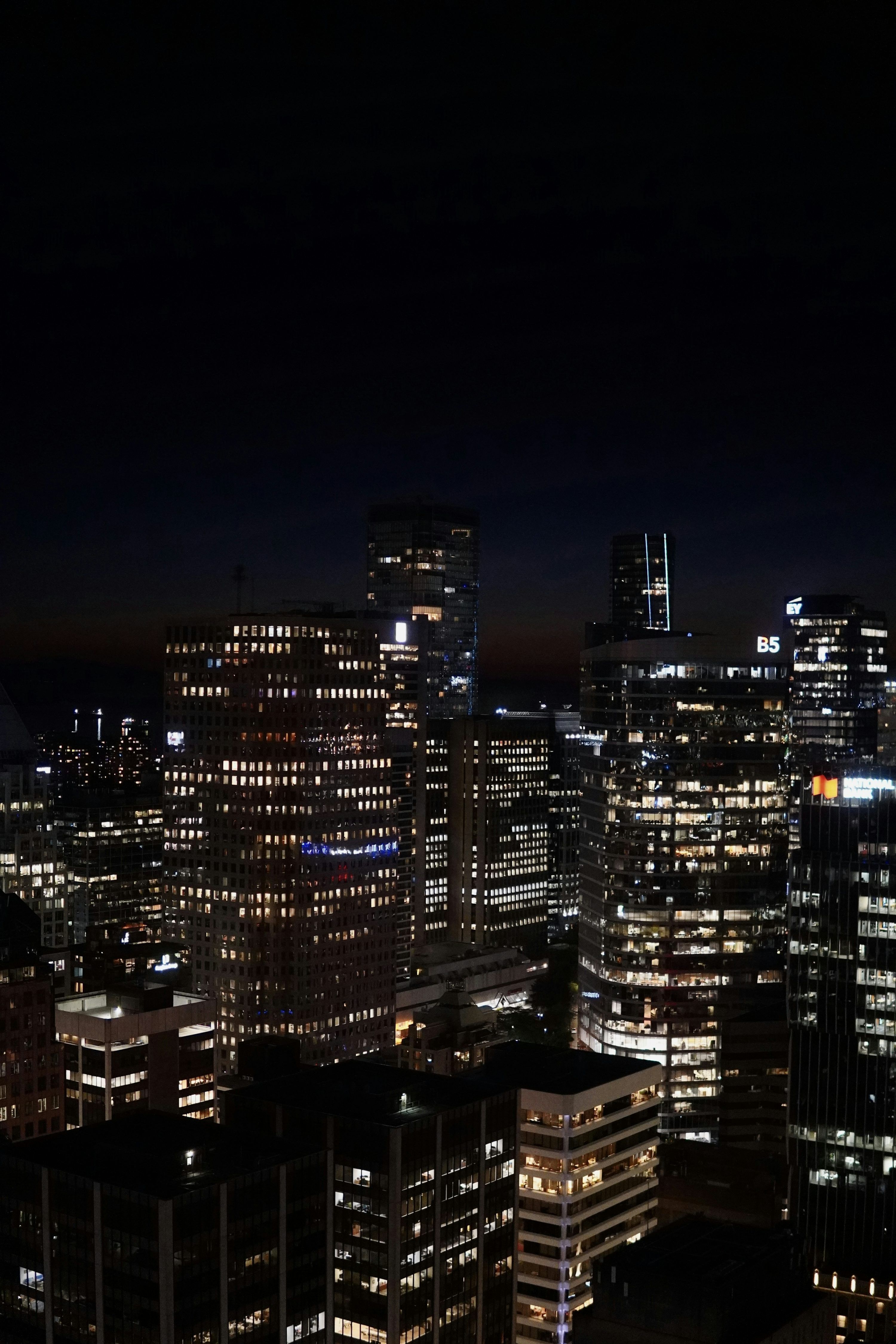 3000x4500 A view of a city at night from the top of a building photo