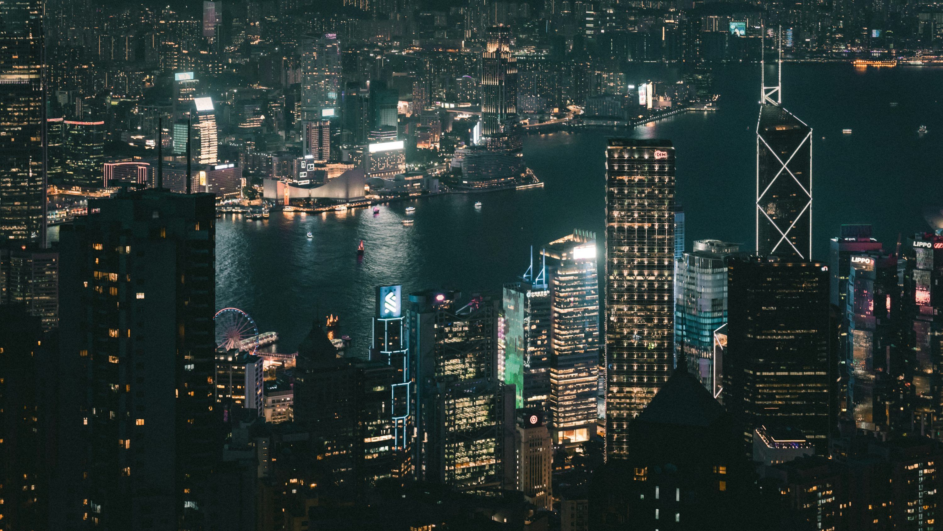 3000x1688 A view of a city at night from the top of a building photo