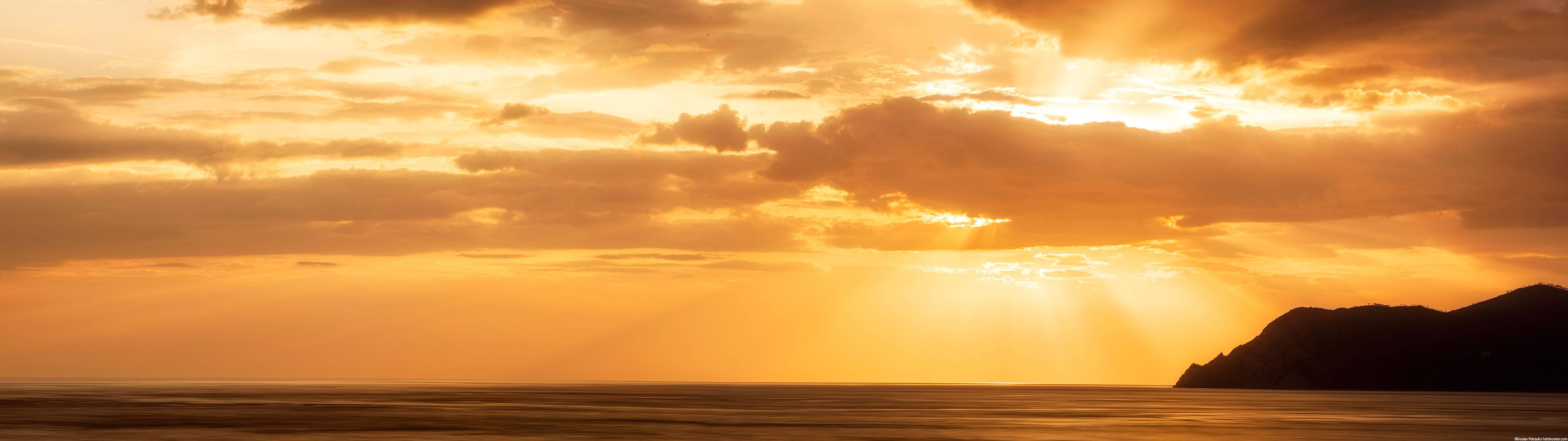 5122x1440 Download A breathtaking view of the sunset from an ultrawide perspective. Wallpaper