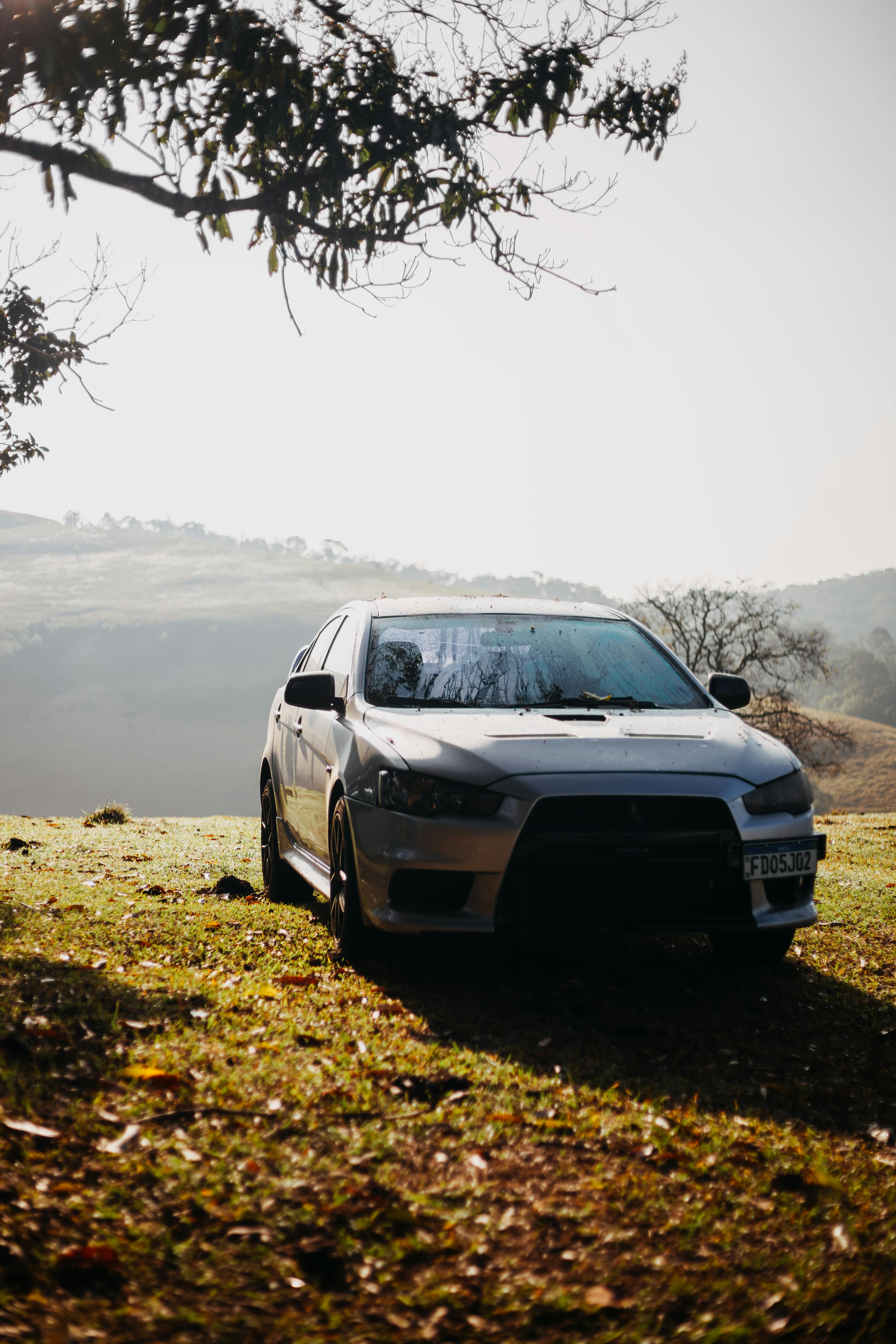 4400x6600 White Mitsubishi Lancer Evolution Car Parked on a Hill · Free