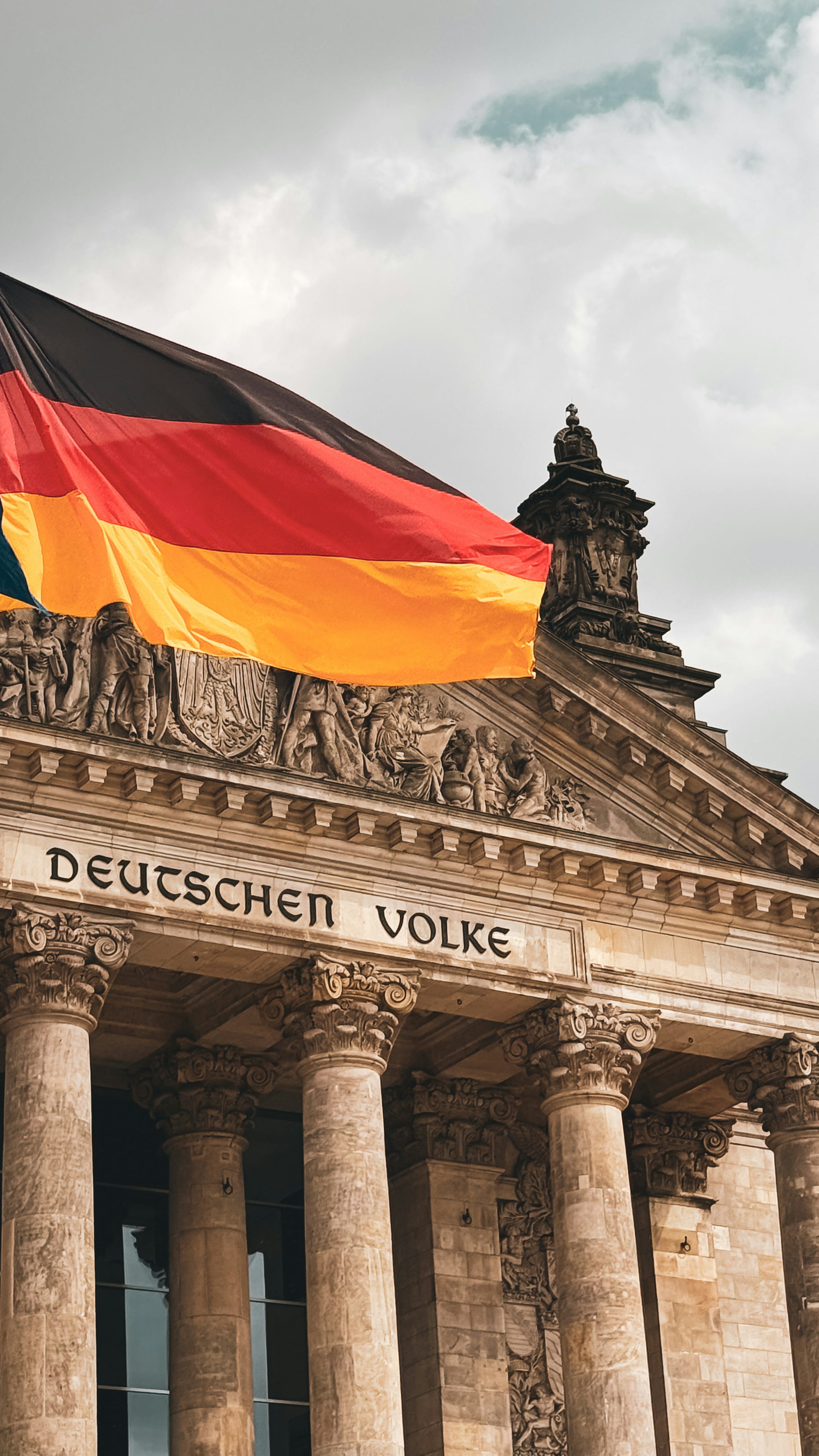 3000x5333 The german flag waves above the reichstag building. photo