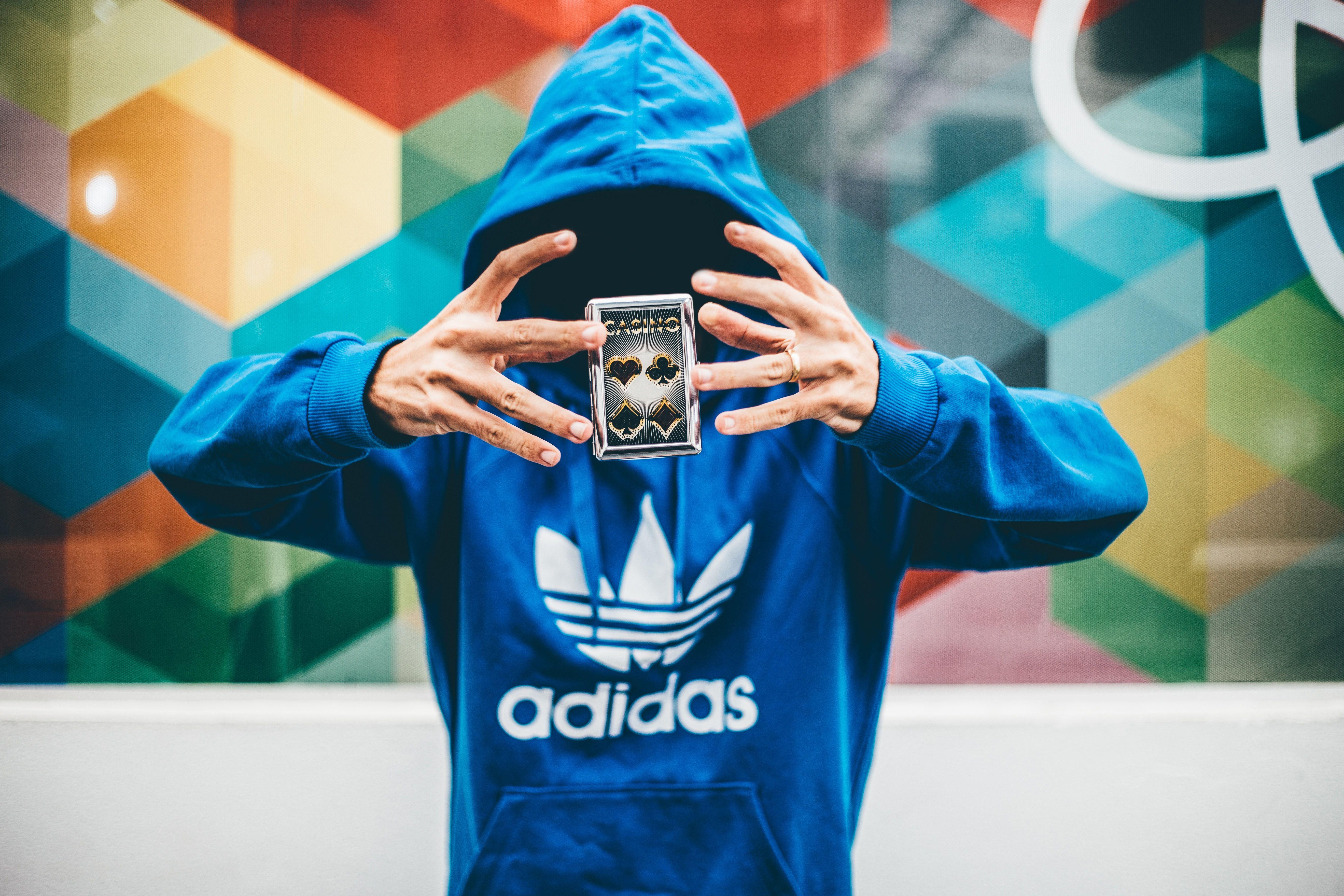 5472x3648 Man in Blue Adidas Hoodie Doing Magic Trick · Free