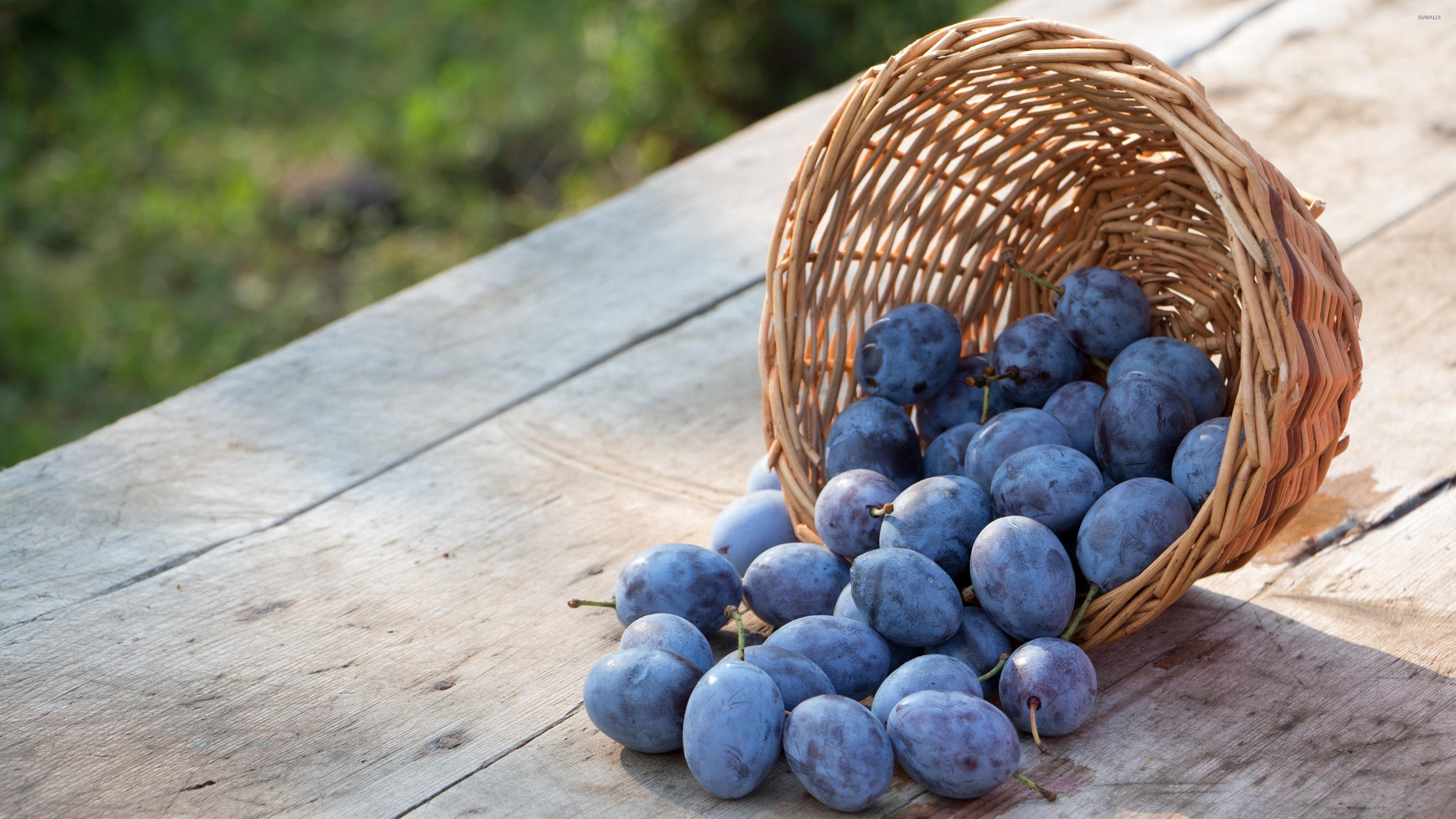 3840x2160 Plums spilled on a wooden table wallpaper wallpaper