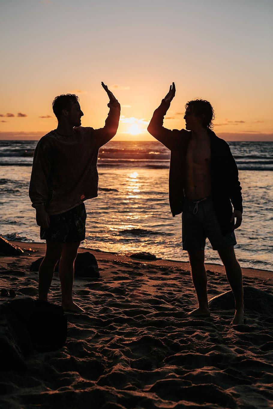 910x1365 HD wallpaper: silhouette of two mens near seashore about to high