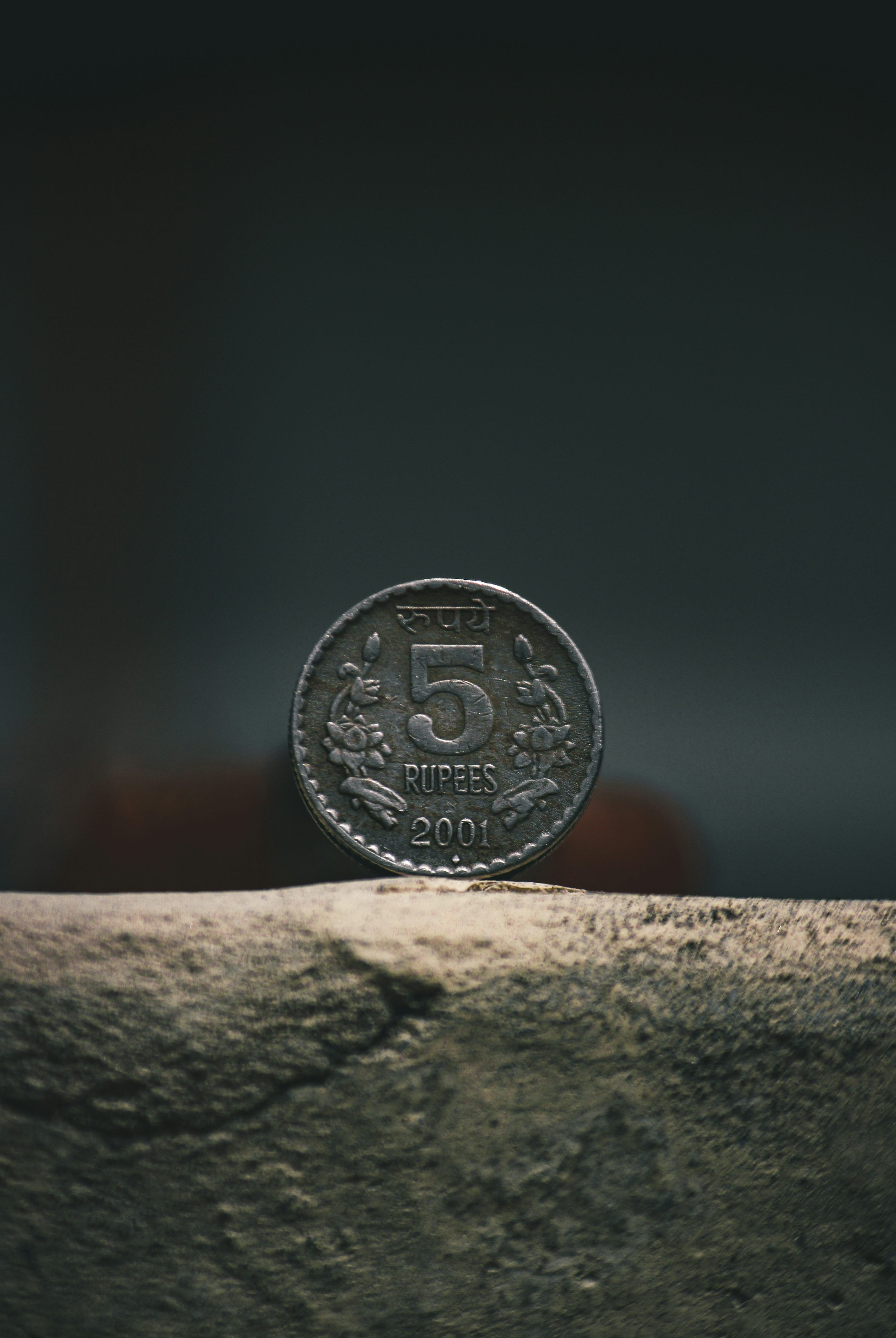 3000x4478 Silver round coin on brown concrete surface photo