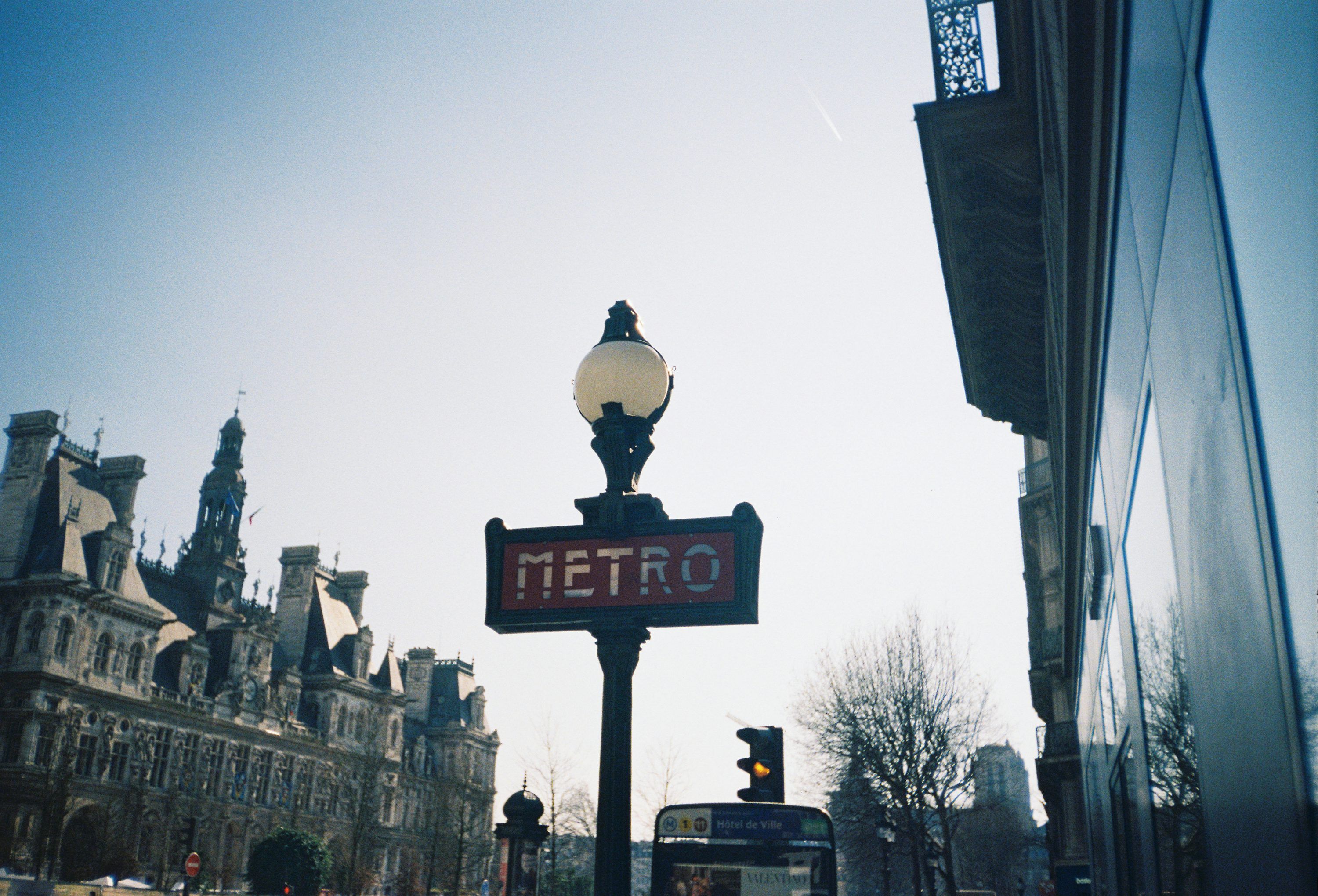 3000x2039 A parisian metro sign stands in the sunlight. photo
