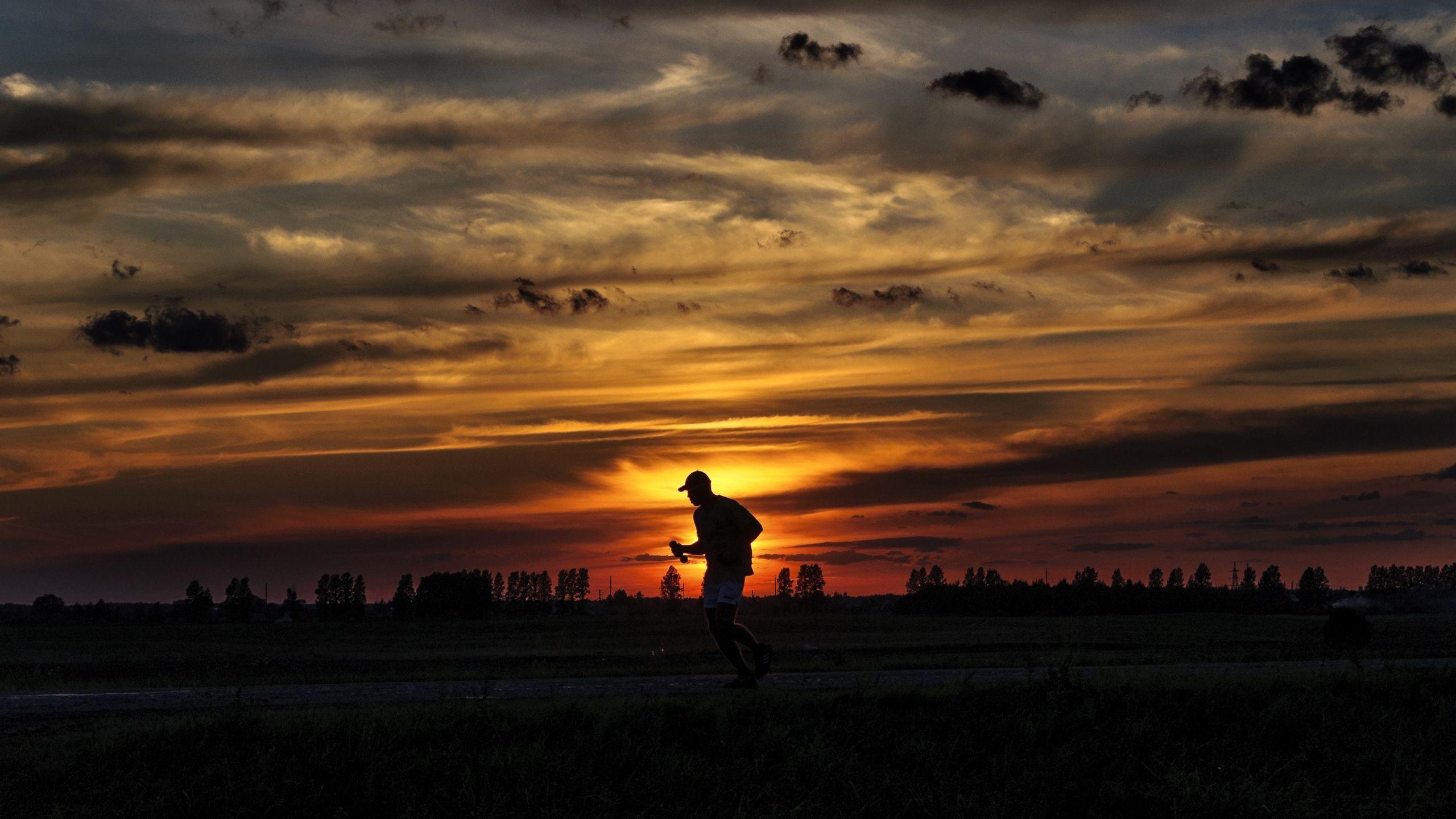 2560x1440 Download wallpaper 2560x1440 silhouette, running, sunset, athlete