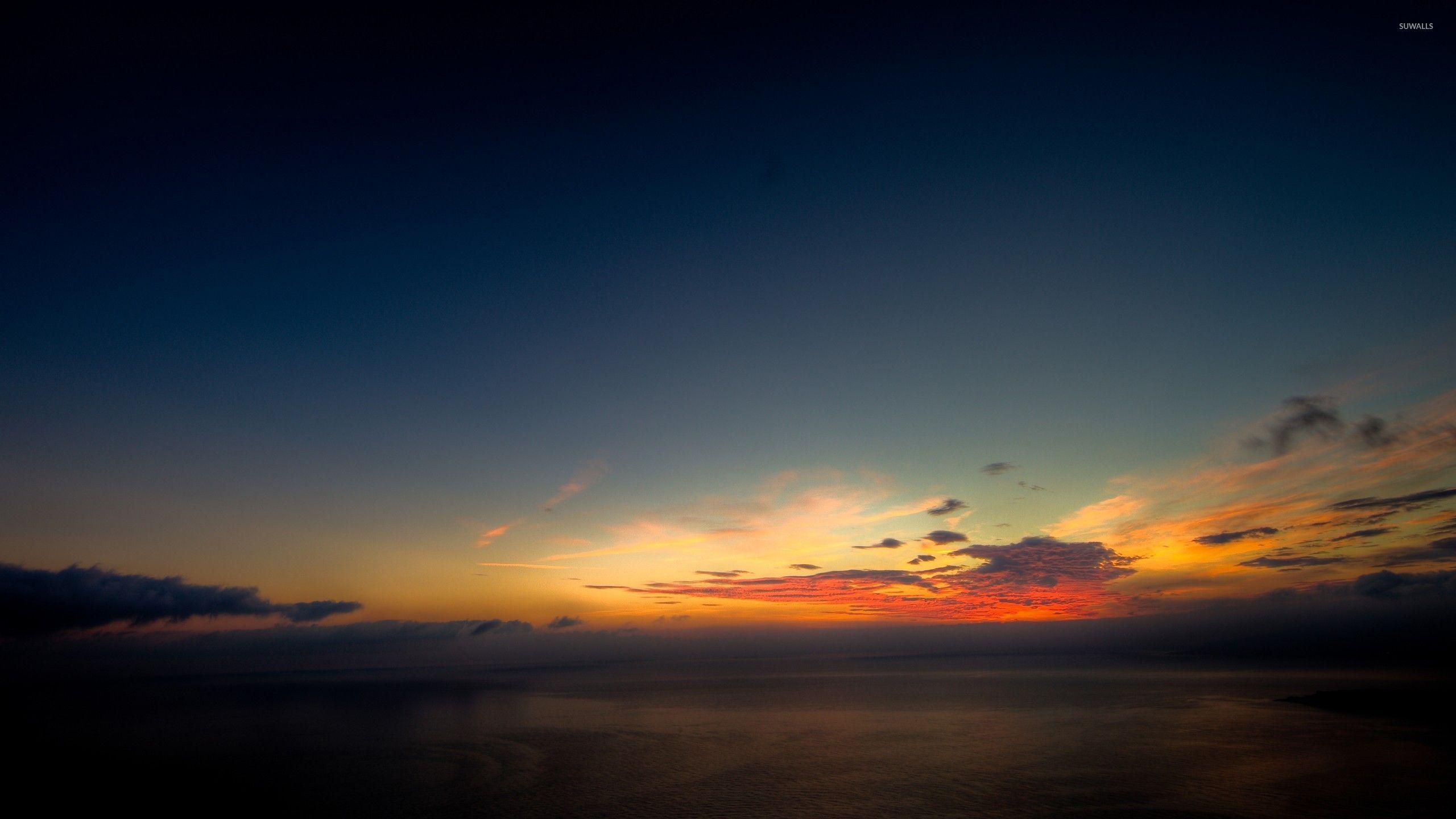 2560x1440 Serene sunset above the ocean wallpaper wallpaper