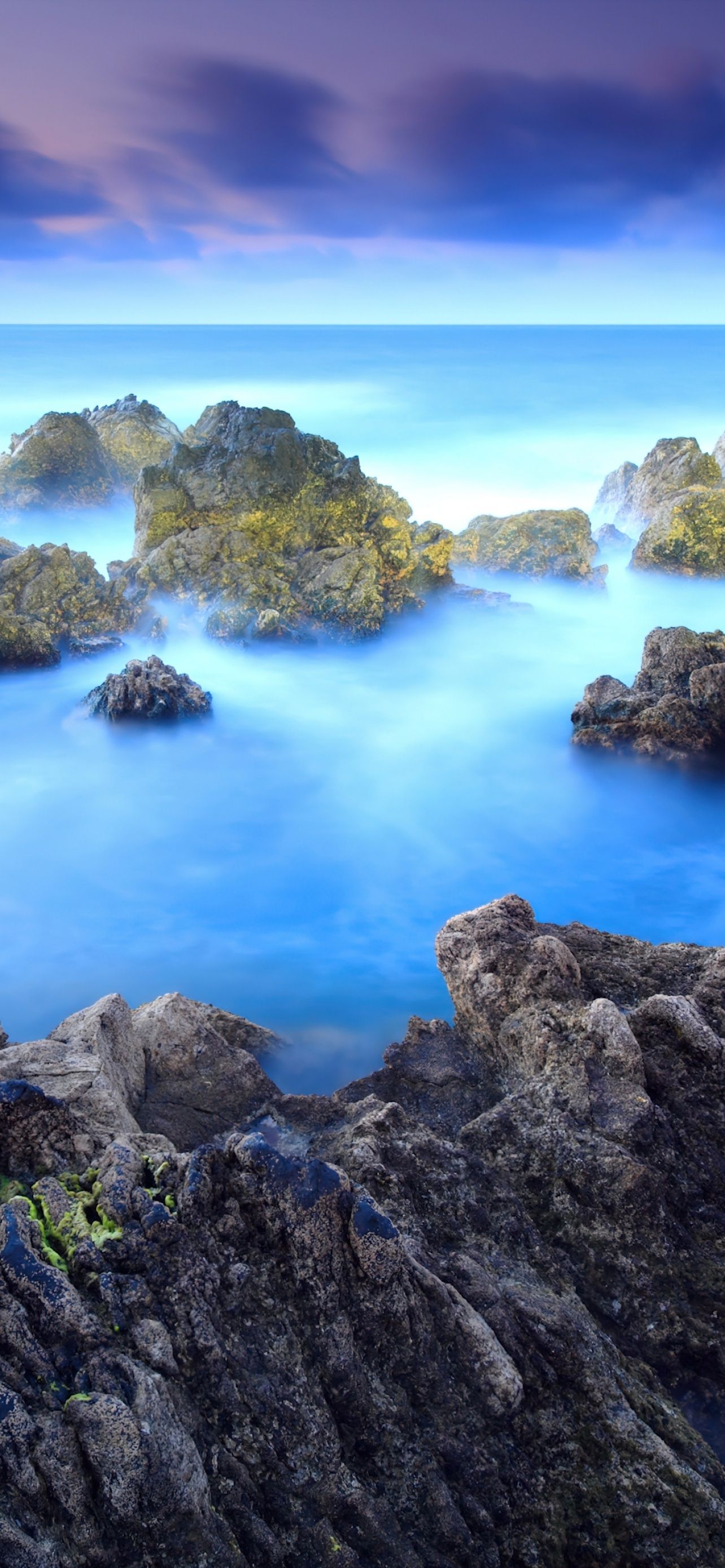 1284x2778 Rocky Shore Porto Moniz Fog Long Exposure Blue Rocks