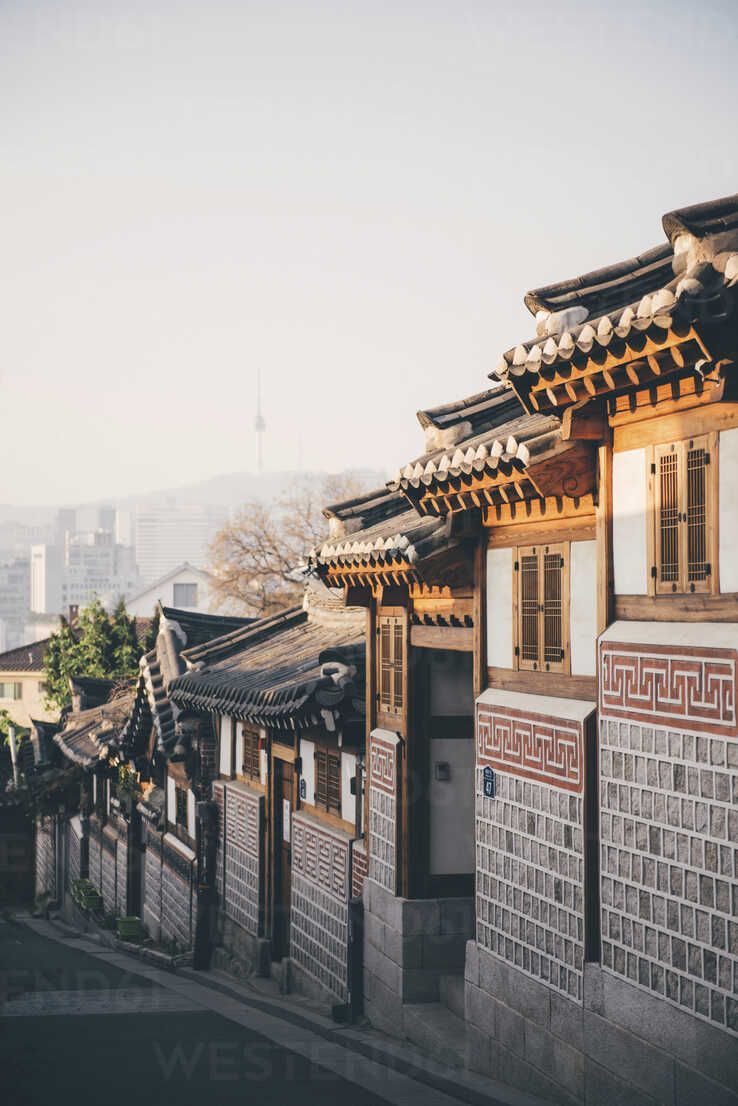 738x1106 South Korea, Bukchon Hanok Village, street with traditional houses, Seoul Tower in the background