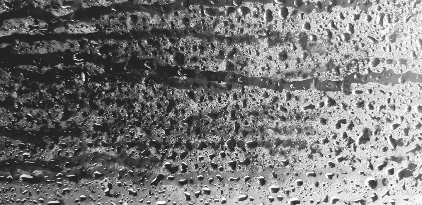 1440x700 Art pattern of steam, vapor or water droplet on glass or mirror for background. Selective focus and Blurred. Humidity, Abstract wallpaper and wet after rain drop concept