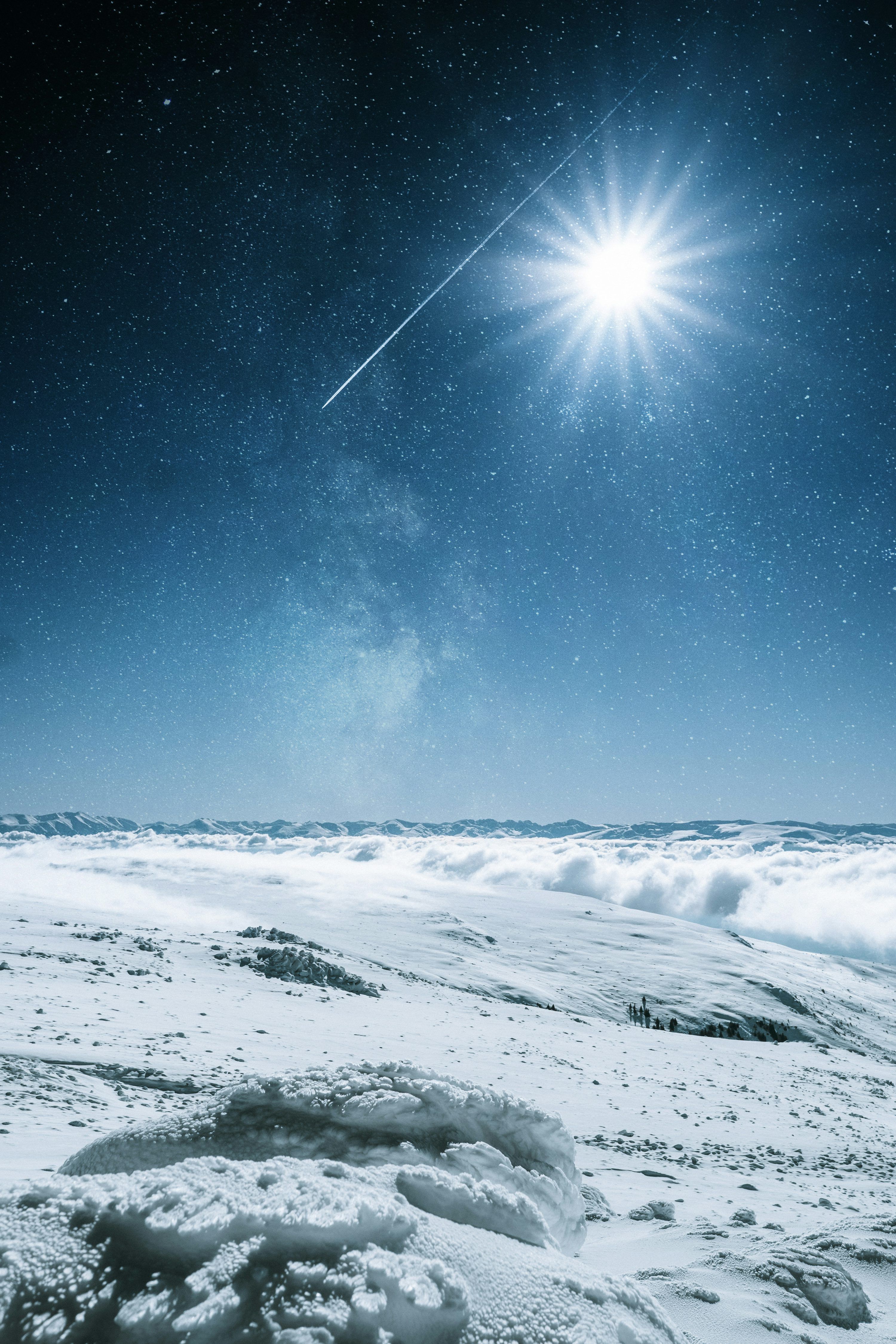 3000x4500 A bright star shines above a snowy landscape photo