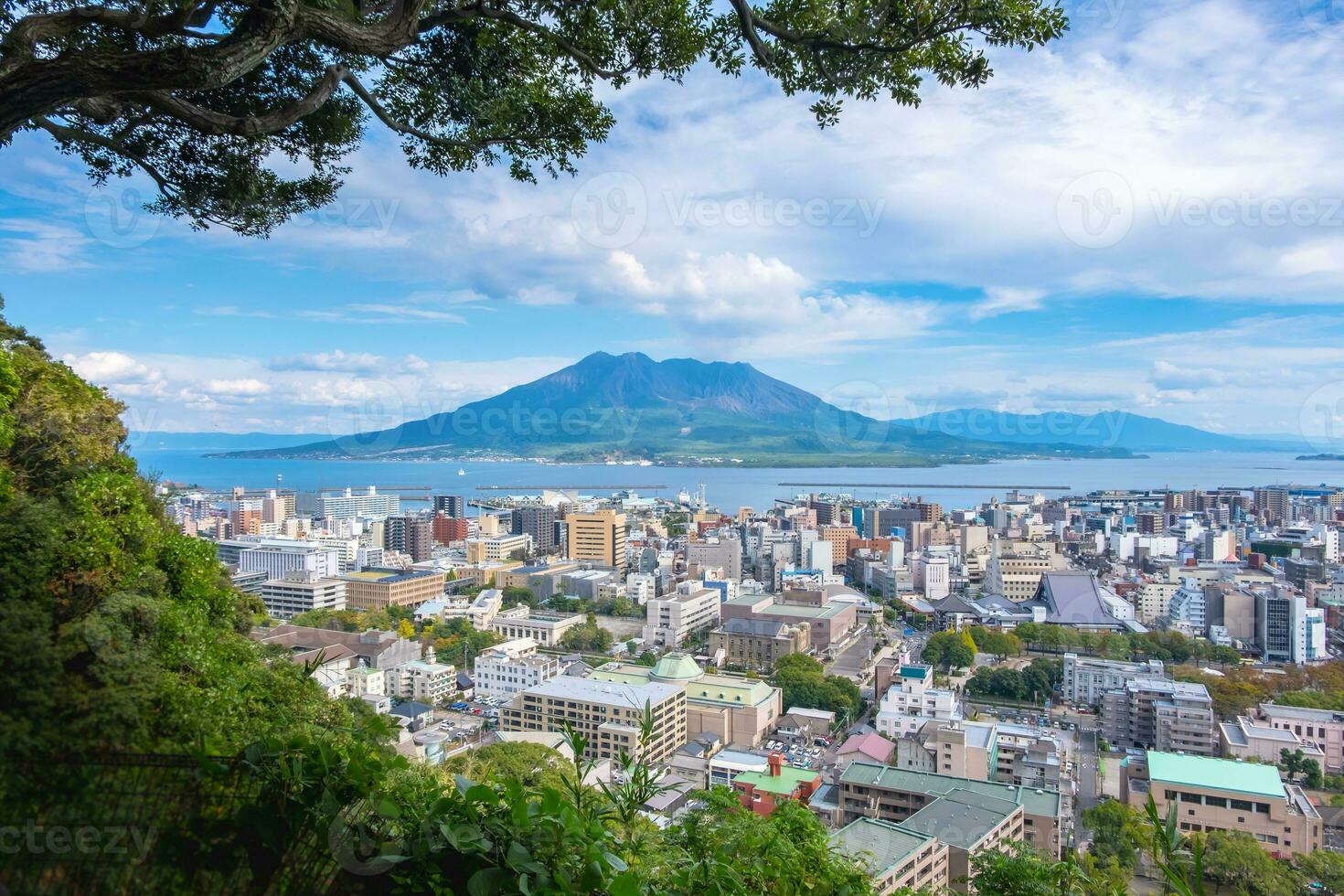 1470x980 Cityscape with Sakurajima mountain, sea and blue sky background view from Shiroyama Park Observation park, Kagoshima, Kyushu, Japan