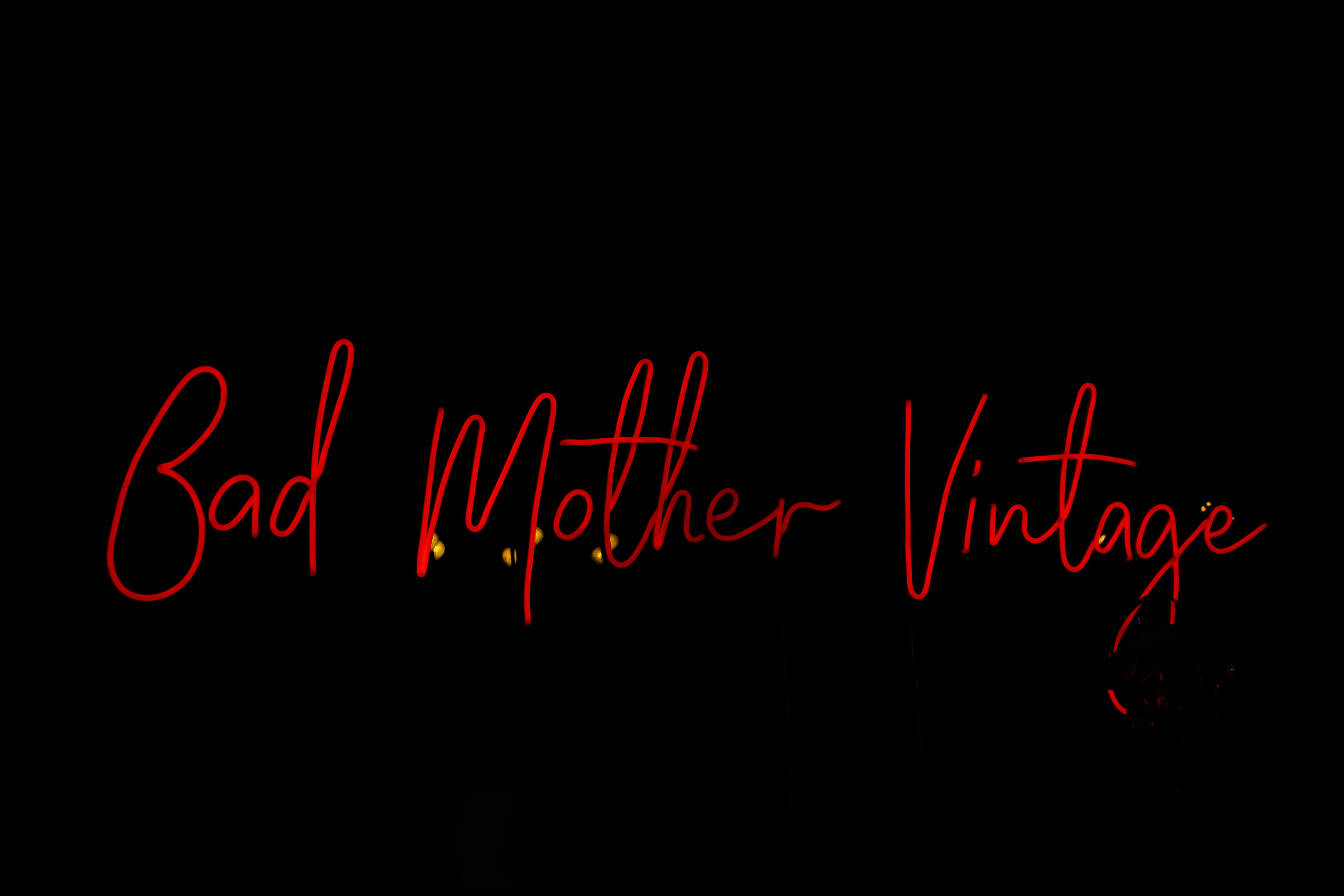 6000x4000 A Bad Mother Vintage Signage in Red Neon Light · Free