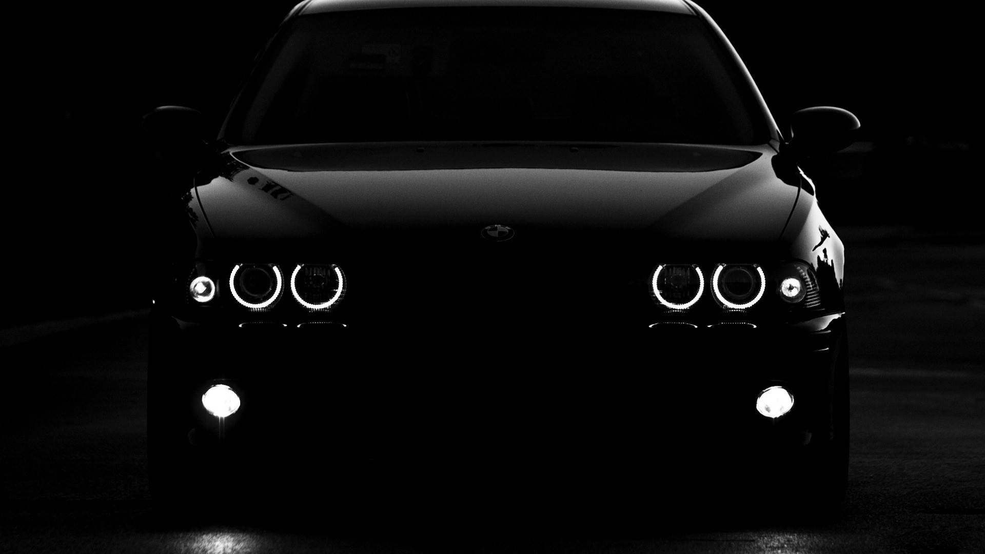 1920x1080 Download Sleek Black Bmw Car In Night City Scenery Wallpaper