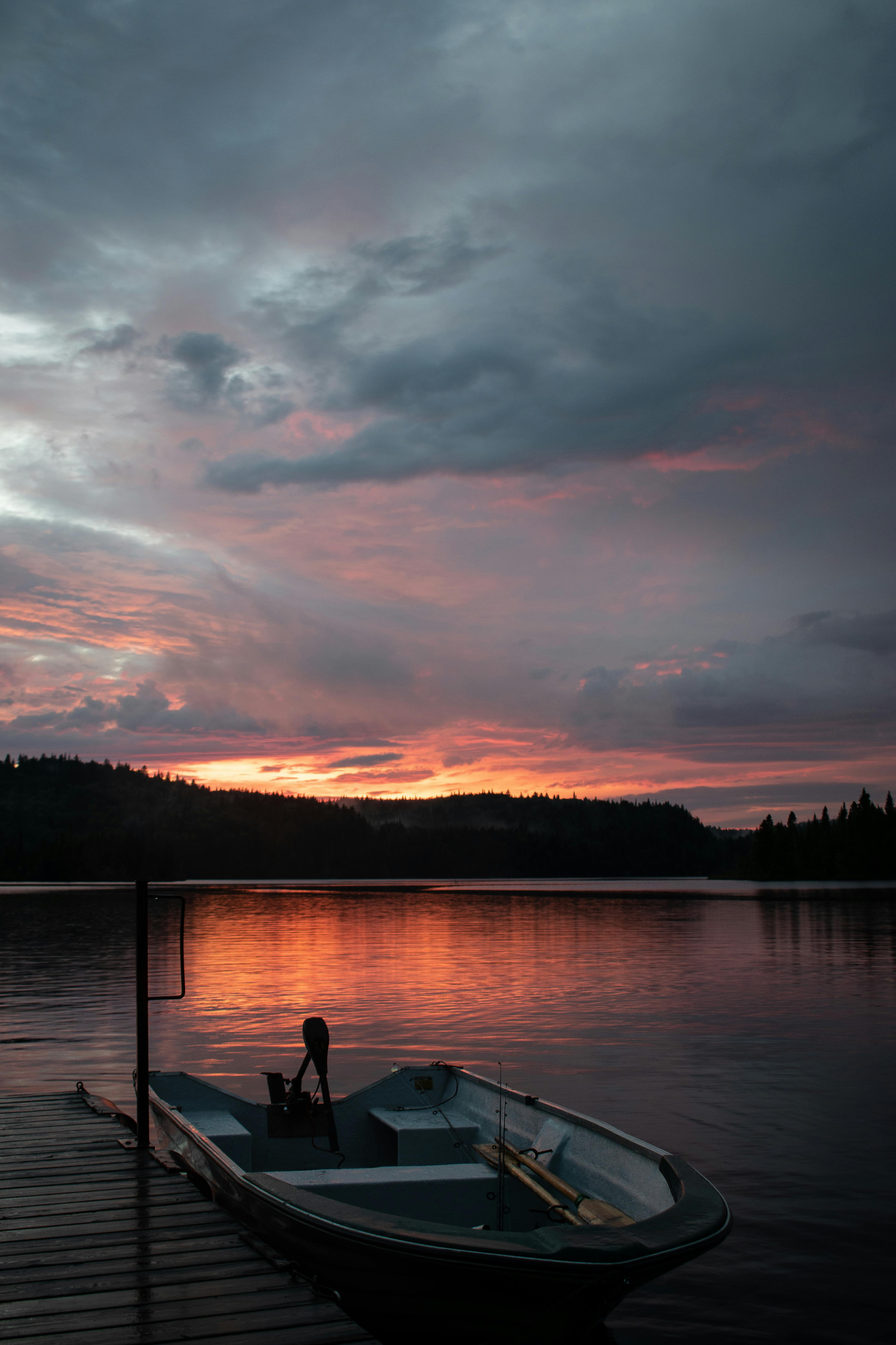 3877x5816 Serene Boat at Sunset on Calm Lake · Free