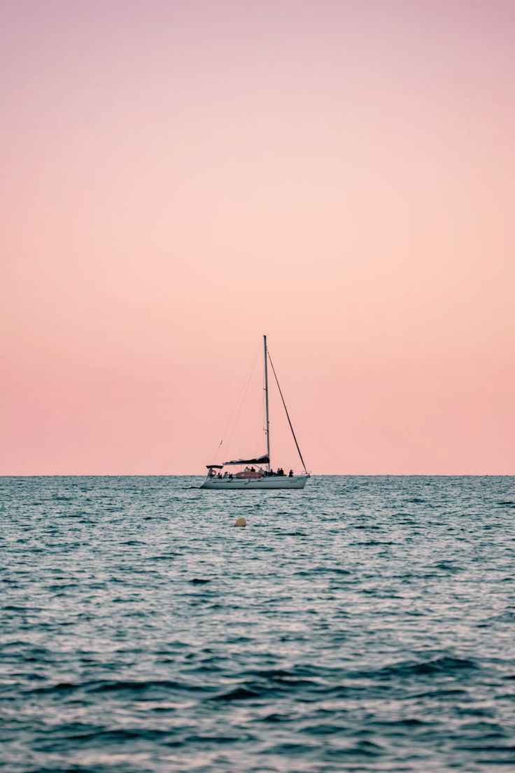 736x1104 Sailing boat wallpaper during the sunset in the blue ocean with a beautiful aesthetic pink sky