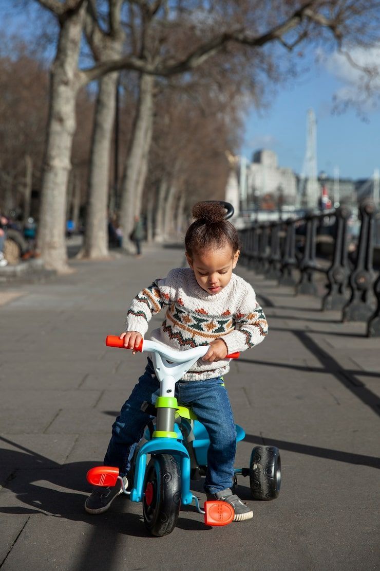 740x1110 Child riding tricycle Image