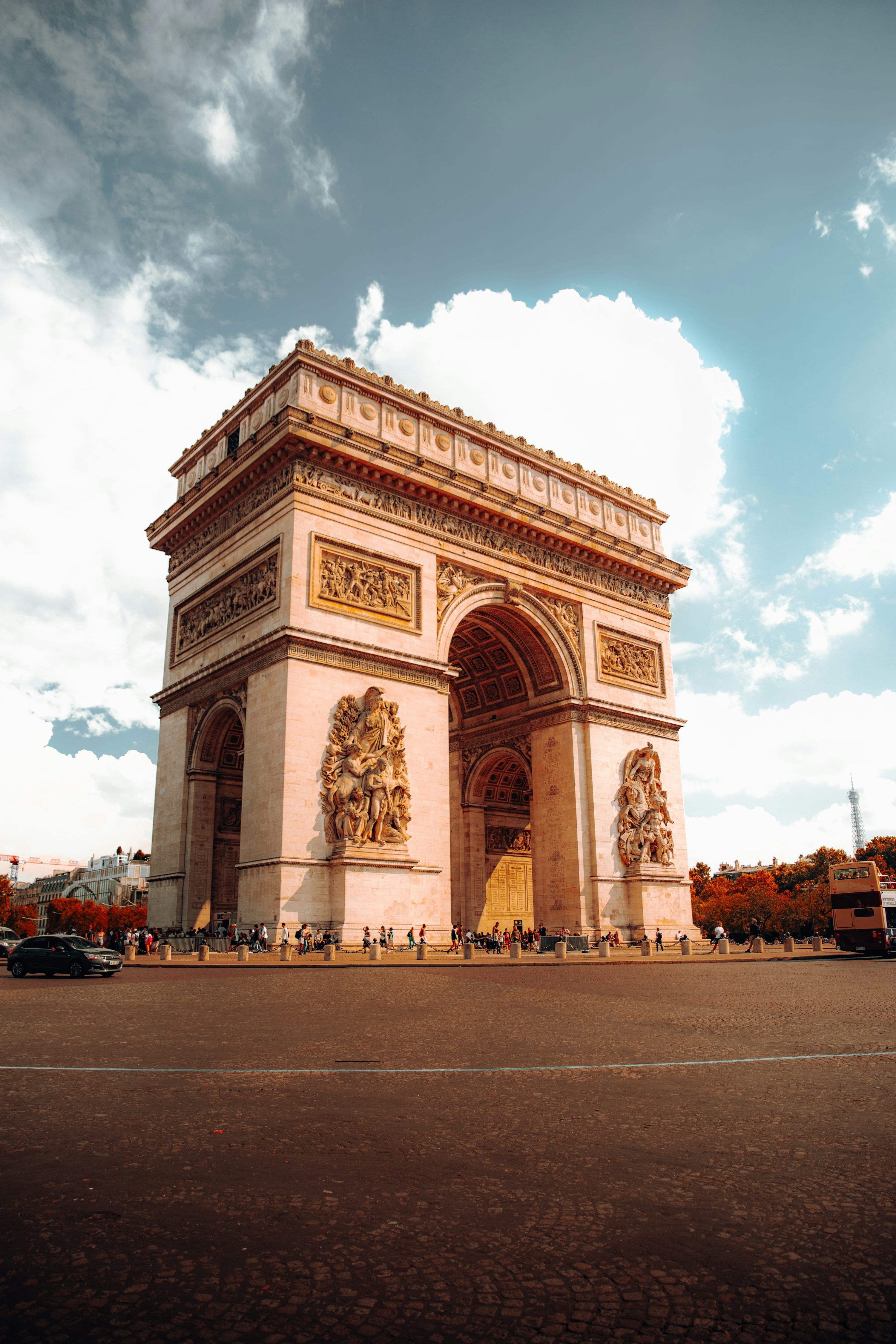3000x4500 A large stone building with a large archway with Arc de Triomphe in the background photo