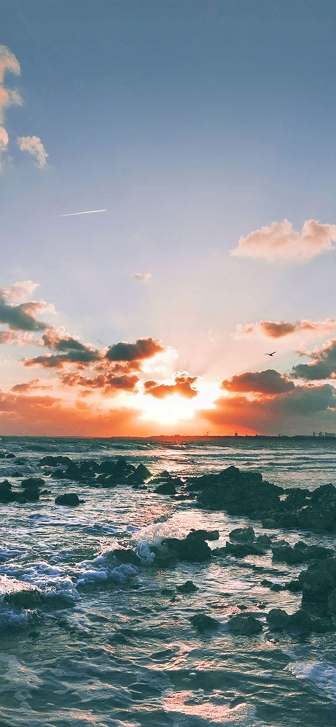 1125x2436 Wallpaper Between The Clouds Sunset