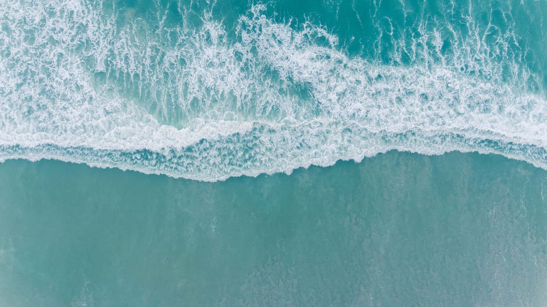 1800x1011 Calming seafoam green aerial ocean wave Wall Mural