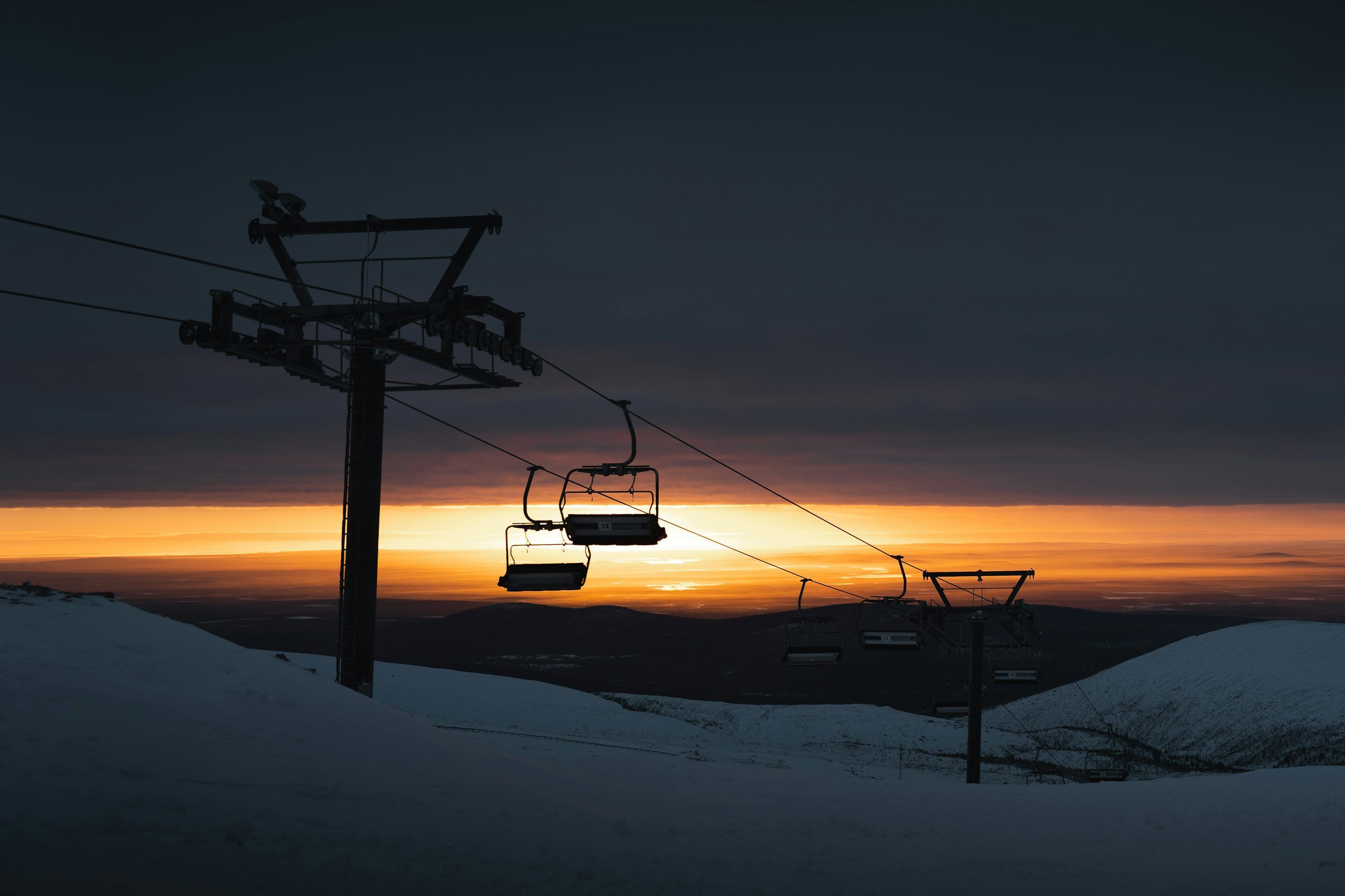 3000x2000 A ski lift with a sunset in the background photo