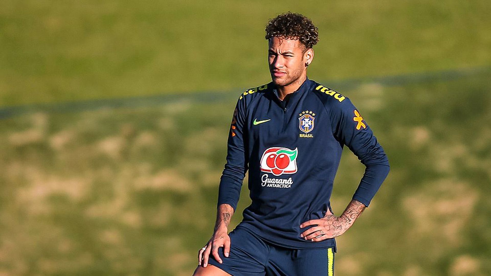 1920x1080 Neymar da Silva Santos Junior Is Standing In Blur Green Grass Background Wearing Blue Sports Dress HD Neymar Wallpaper