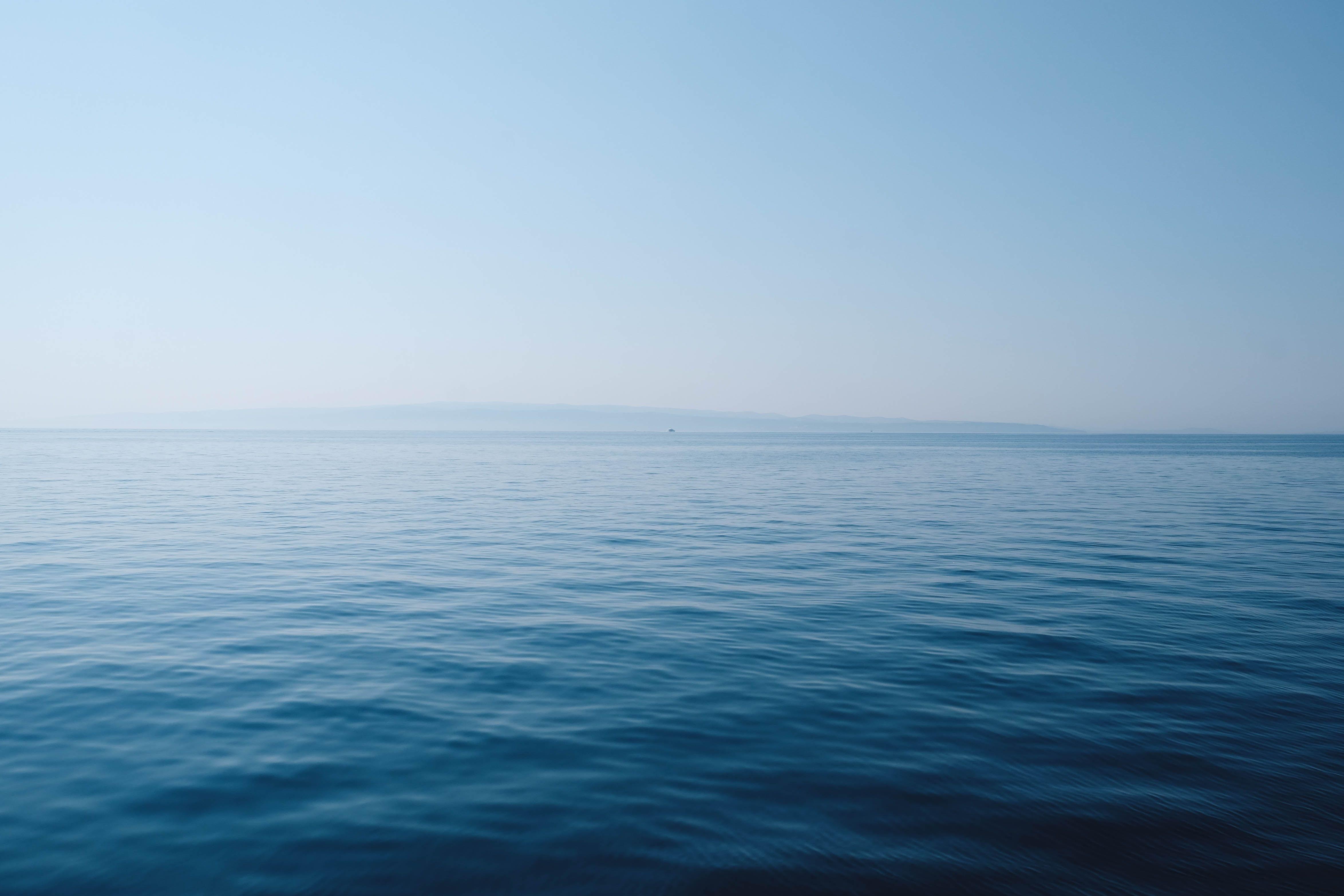4696x3131 body of water under blue and white sky at daytime photo