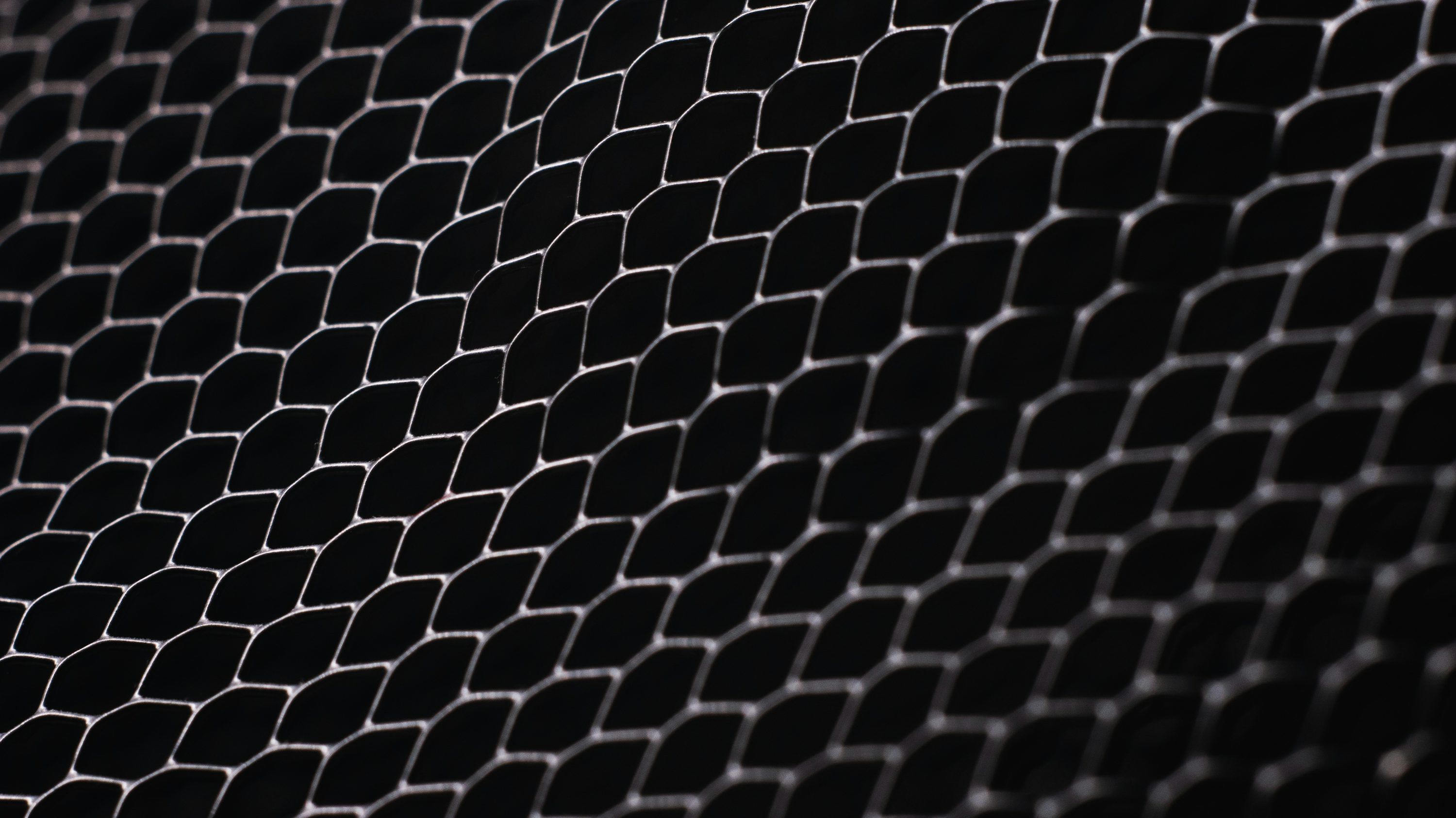 3000x1687 A black and white photo of a metal mesh photo