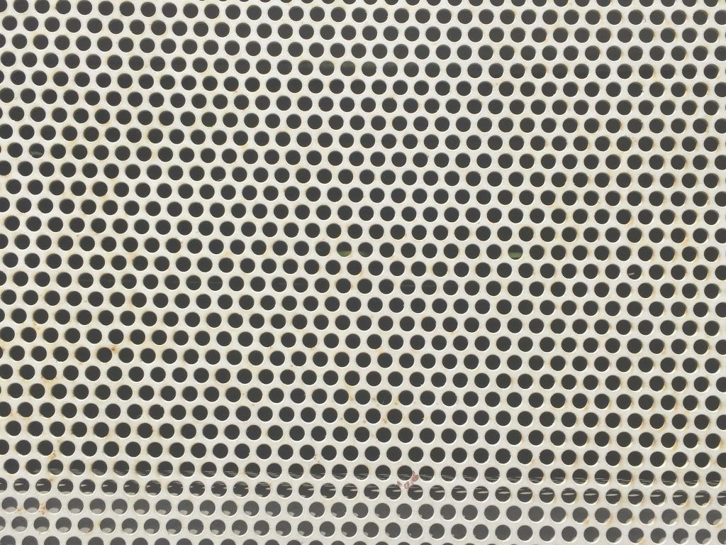 1024x768 Metal mesh with pattern of holes throughout