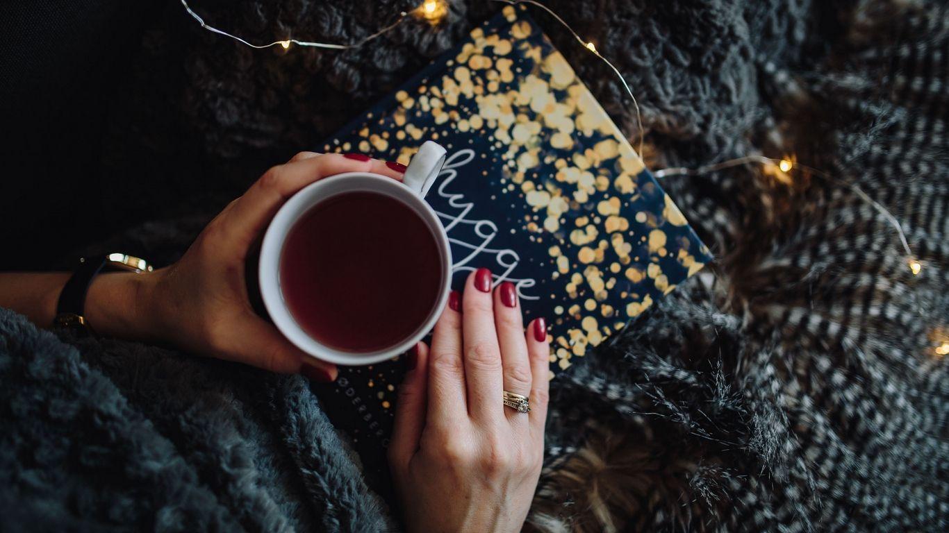 1366x768 Download wallpaper 1366x768 tea, book, hands, manicure, rest