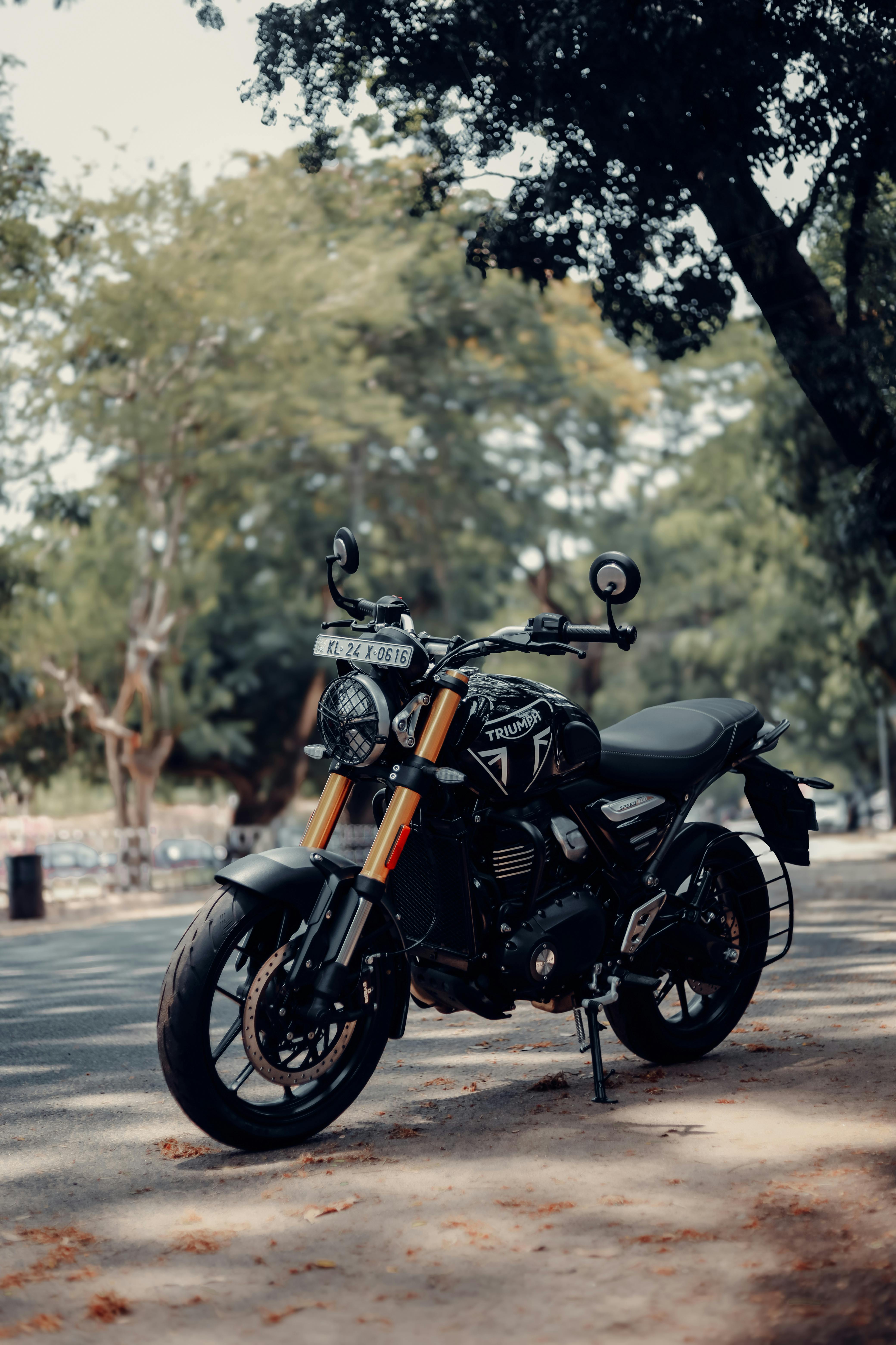 4160x6240 A Triumph Speed 400 Motorcycle Parked on the Side of a Street · Free