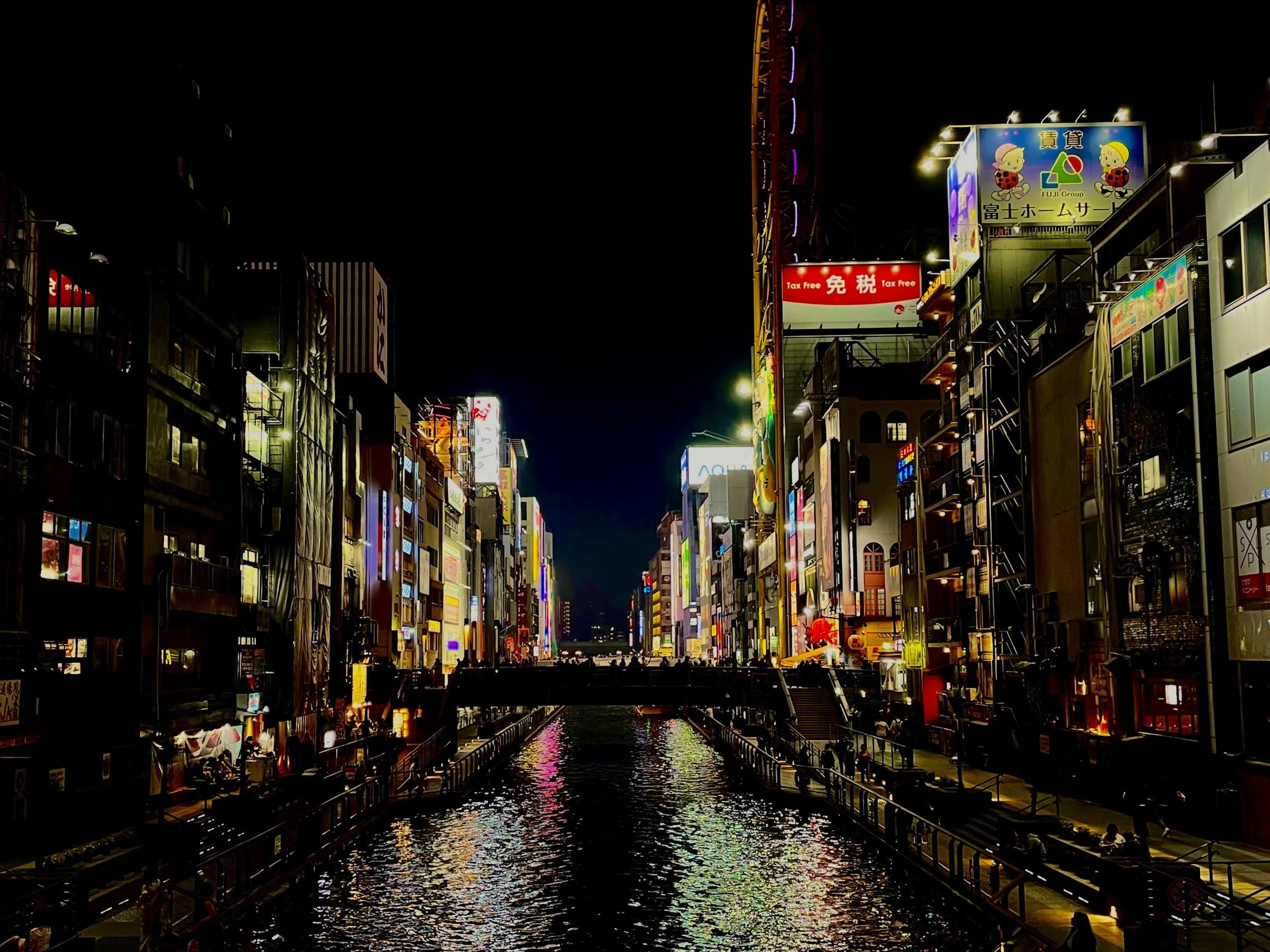 3000x2249 Night view of a brightly lit city with a canal. photo