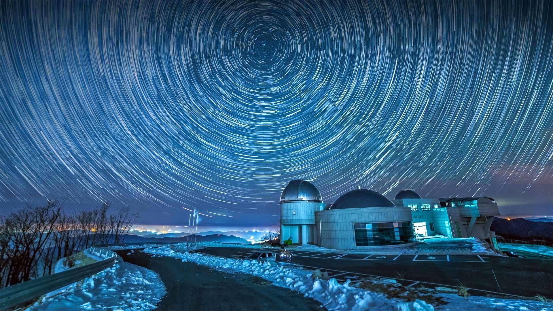 1920x1080 Celestial Vortex: Night Sky Star Trails Over Observatory