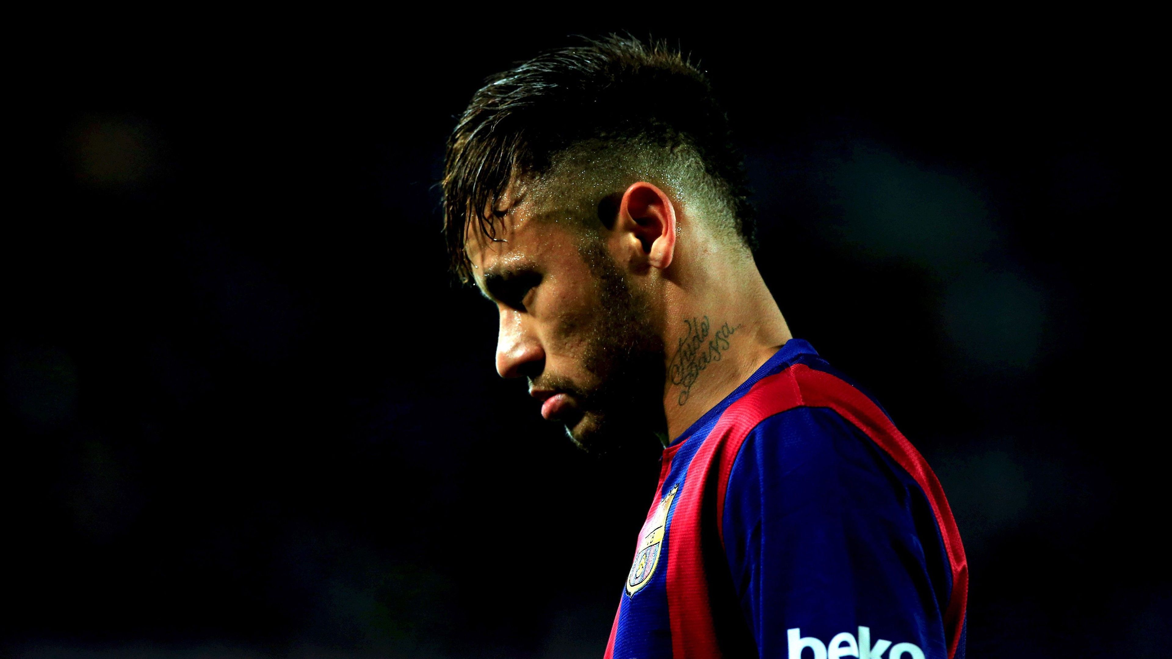 3840x2160 Neymar Is Looking Down Wearing Blue Red Sports Dress In Black Background 4K HD Neymar Wallpaper