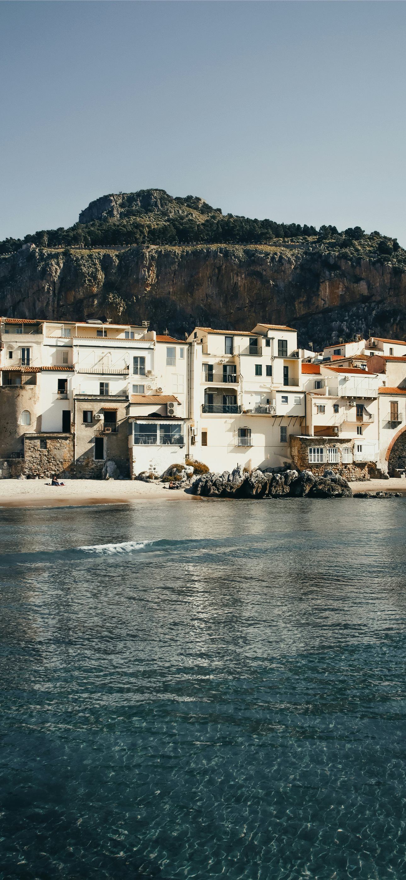 1290x2796 a small town on the shore of a body of water iPhone Wallpaper Free Download