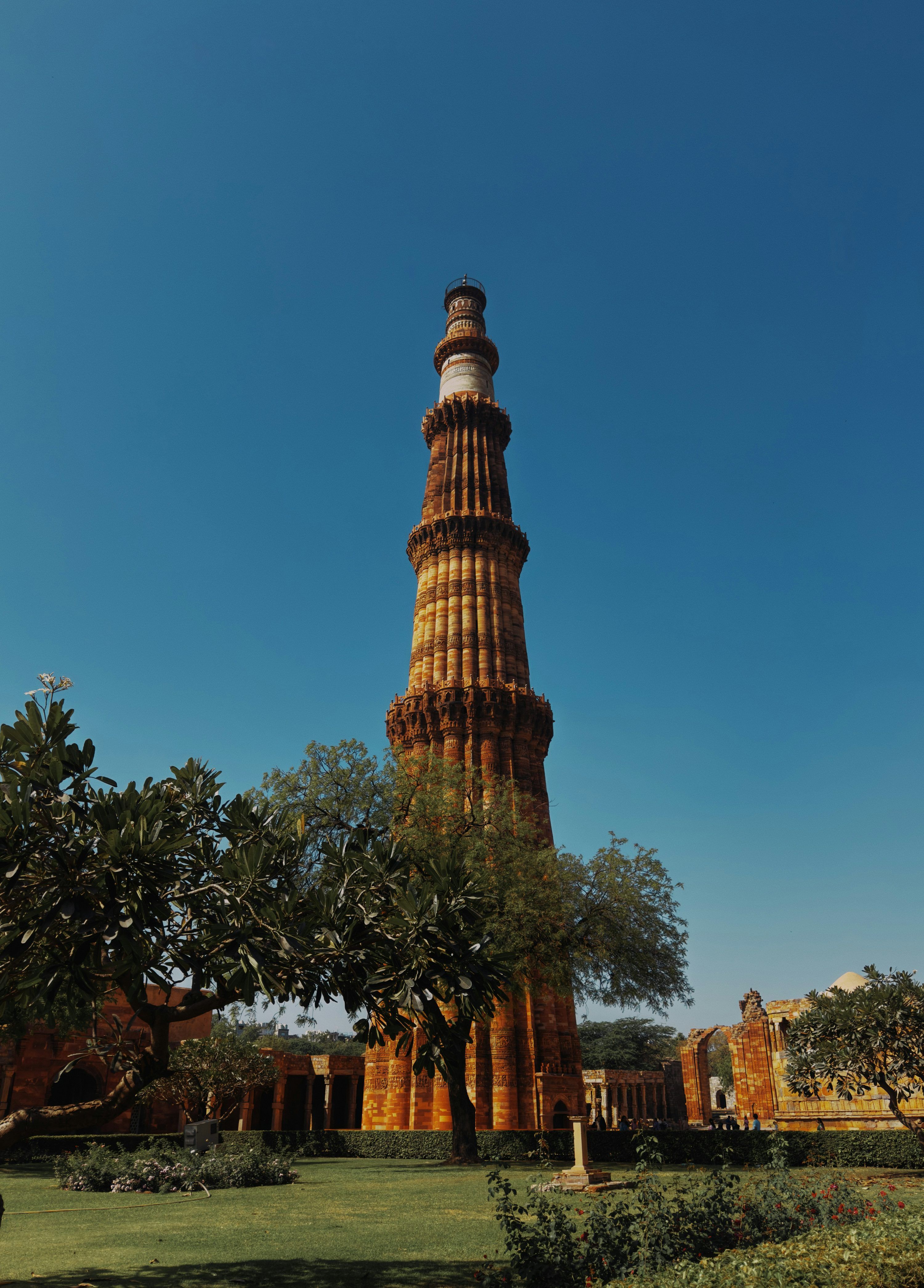 3000x4182 The qutub minar stands tall against a blue sky. photo
