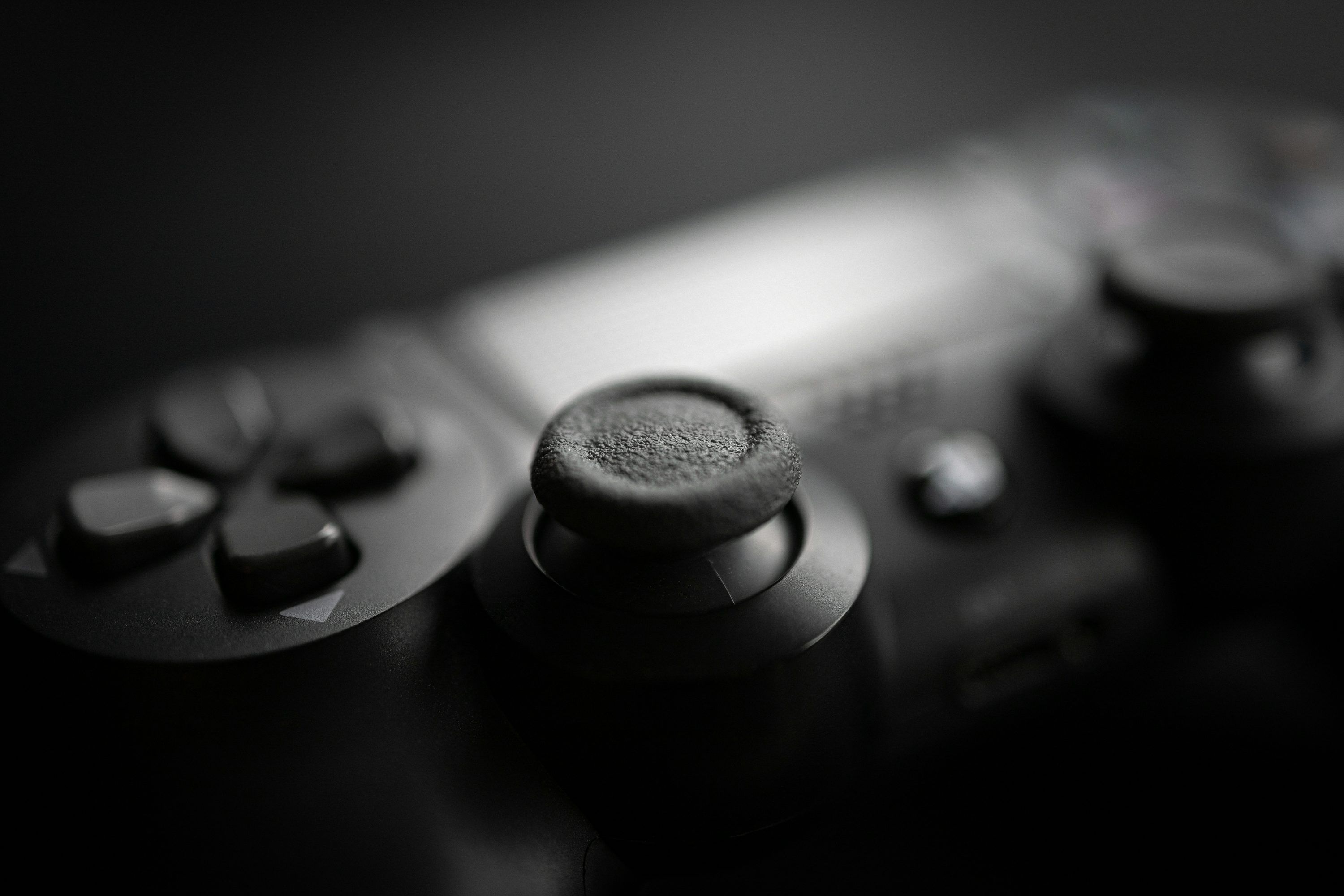 3000x2000 Black game controller on black surface photo