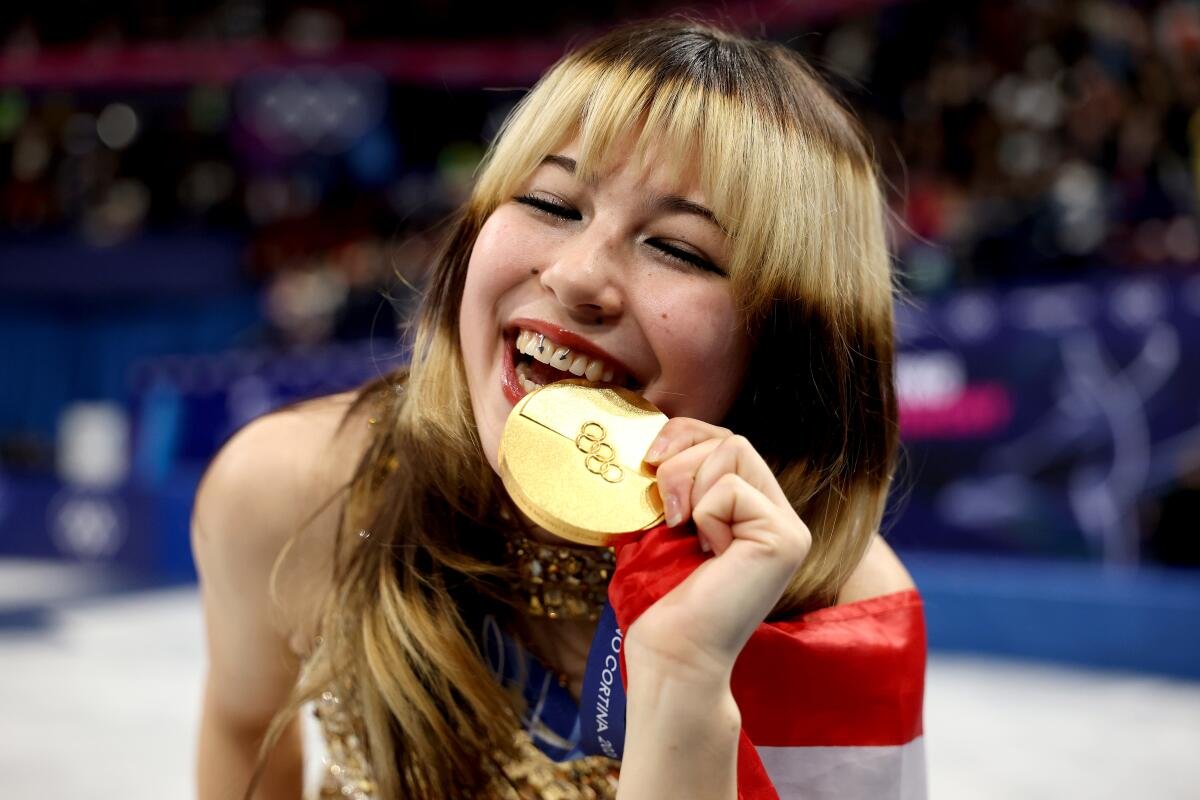 1200x800 Alysa Liu playfully biting her Olympic gold medal at the 2026 Winter Olympics in Cortina