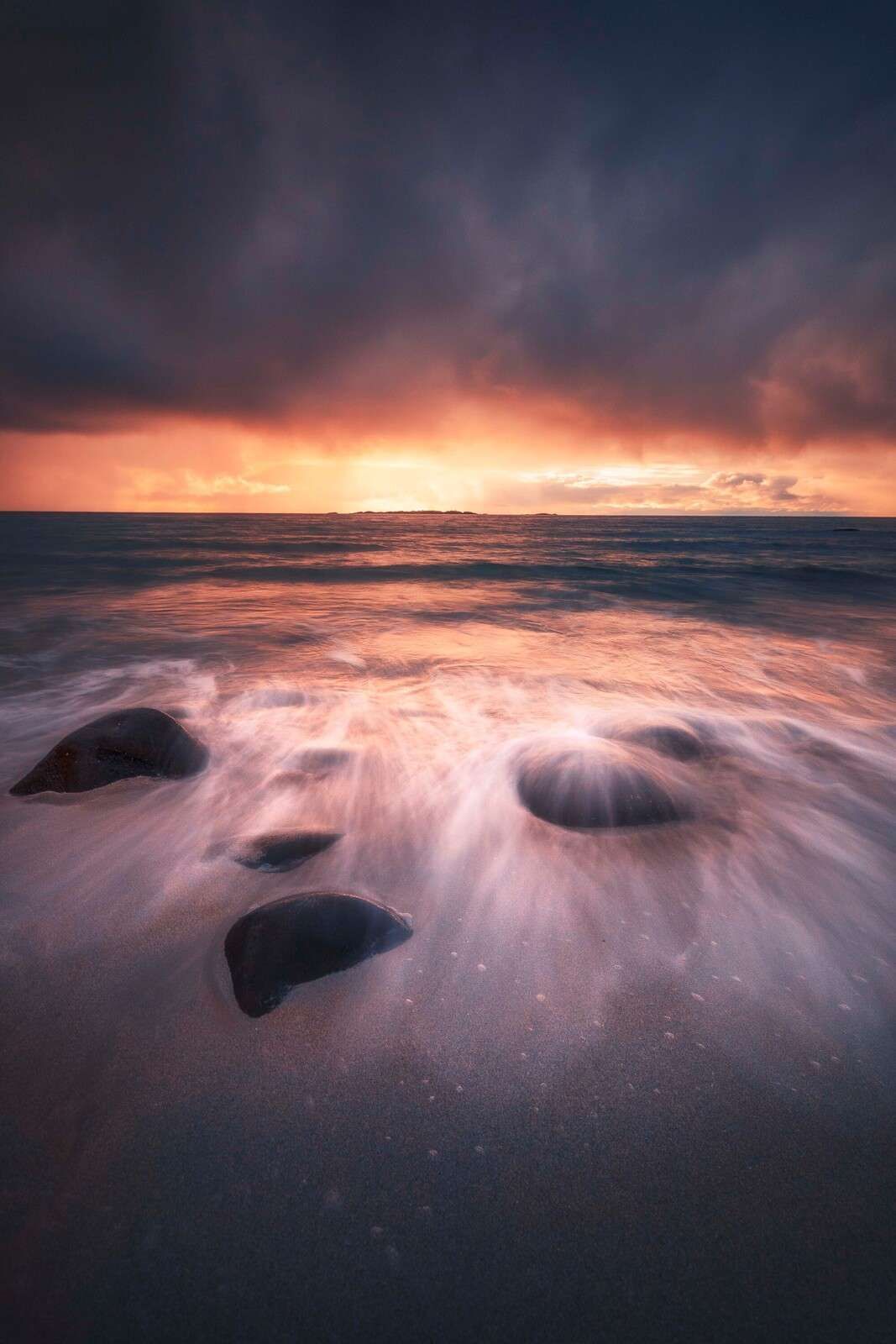 1067x1600 Wall Mural glow over rocky coastline