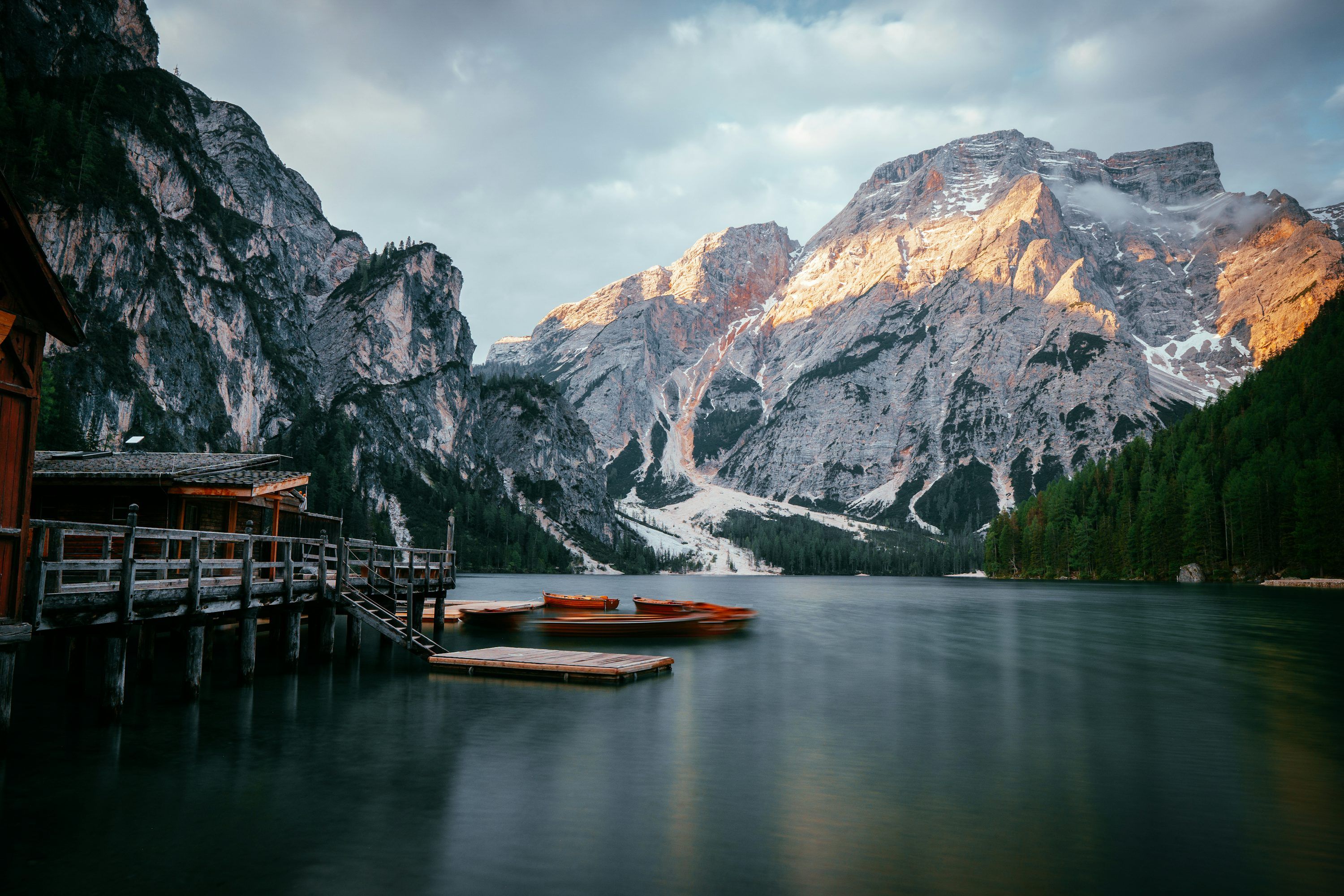 3000x2000 A lake with a dock and mountains in the background photo