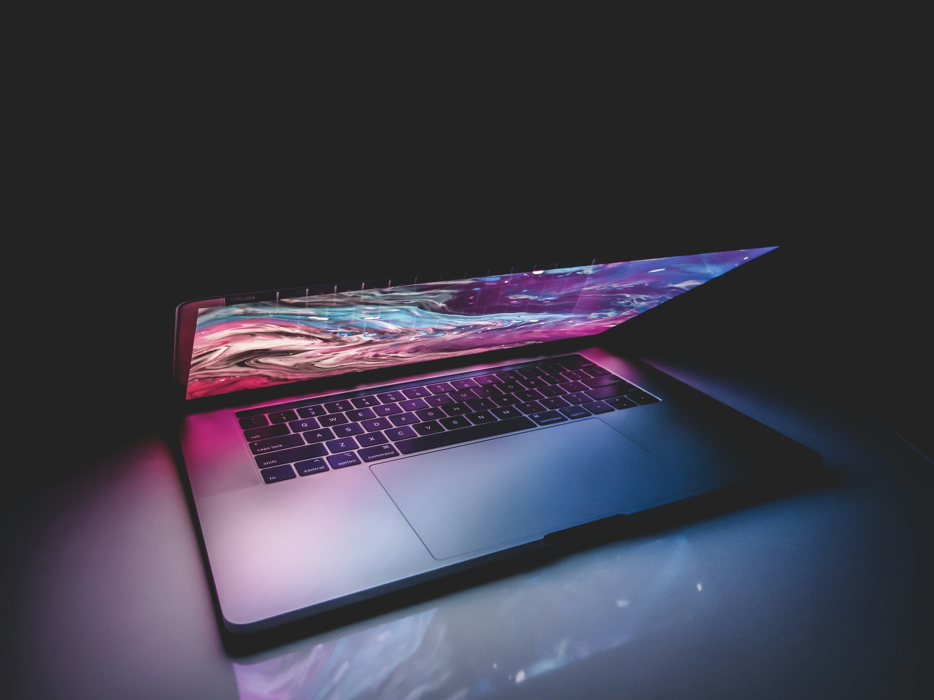 3000x2250 Macbook pro on black surface photo