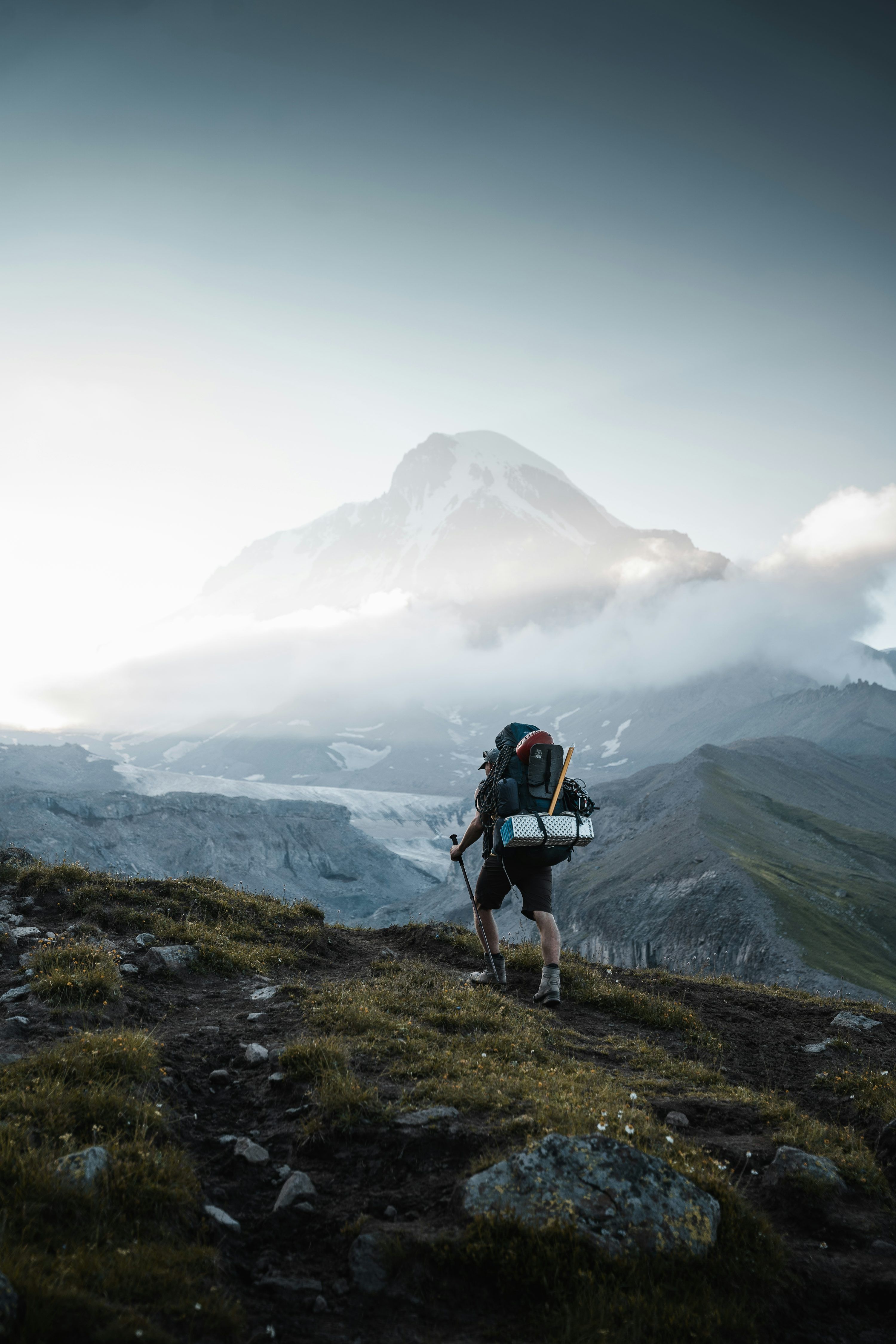 3000x4500 A man hiking up a mountain with a backpack photo