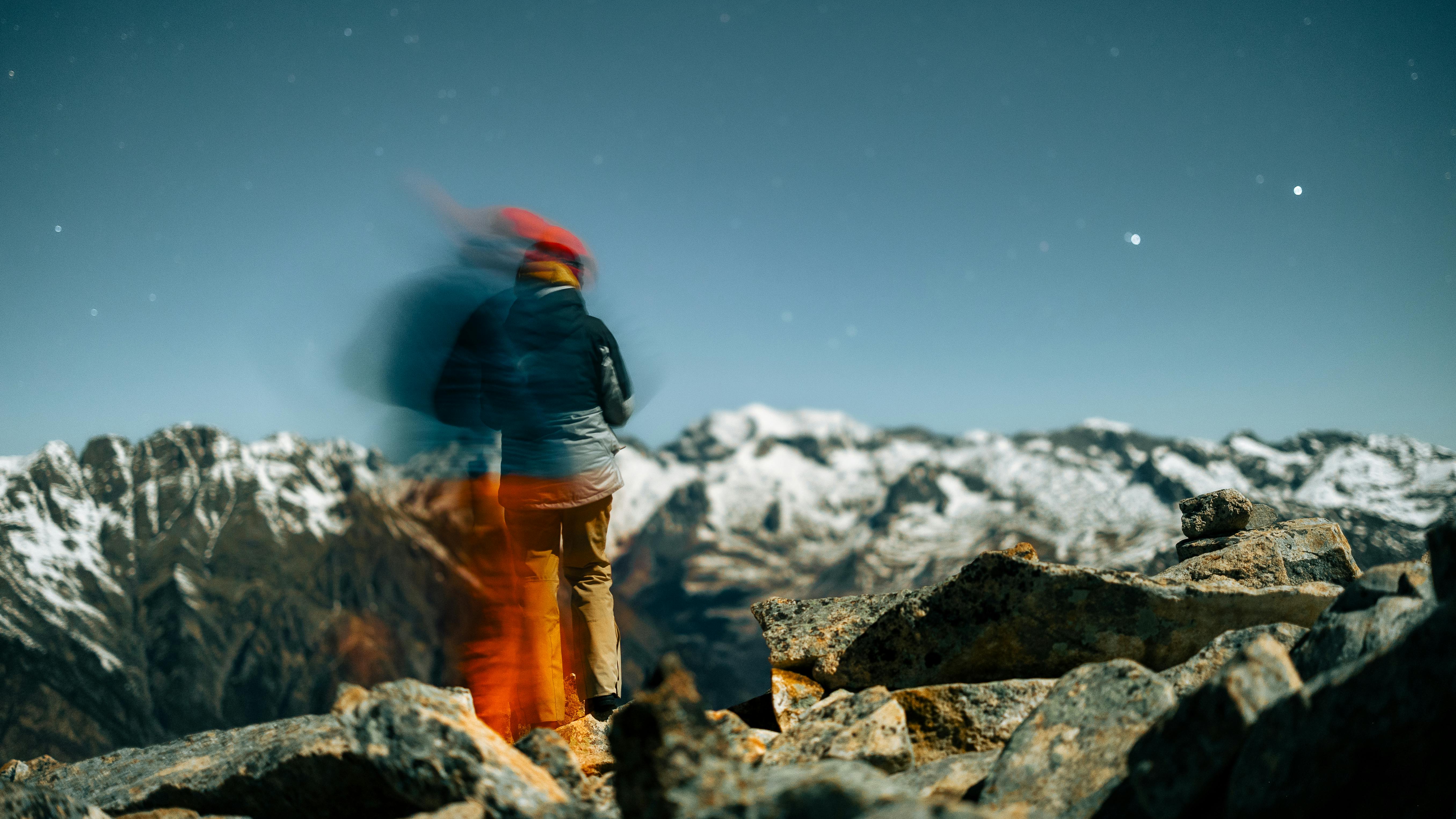5423x3050 A person standing on top of a mountain with a camera · Free