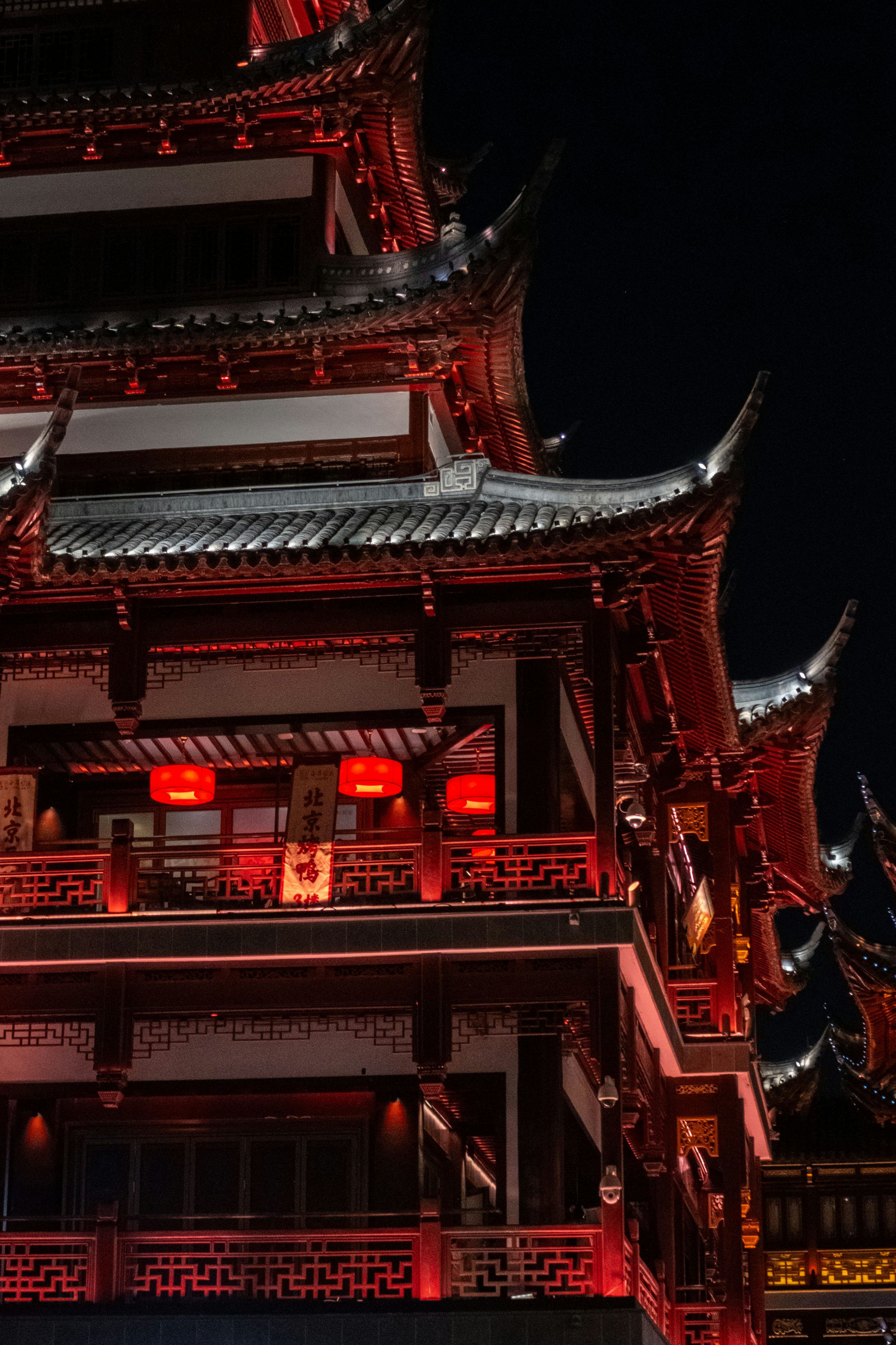 3000x4500 A red, ornate chinese temple shines at night. photo
