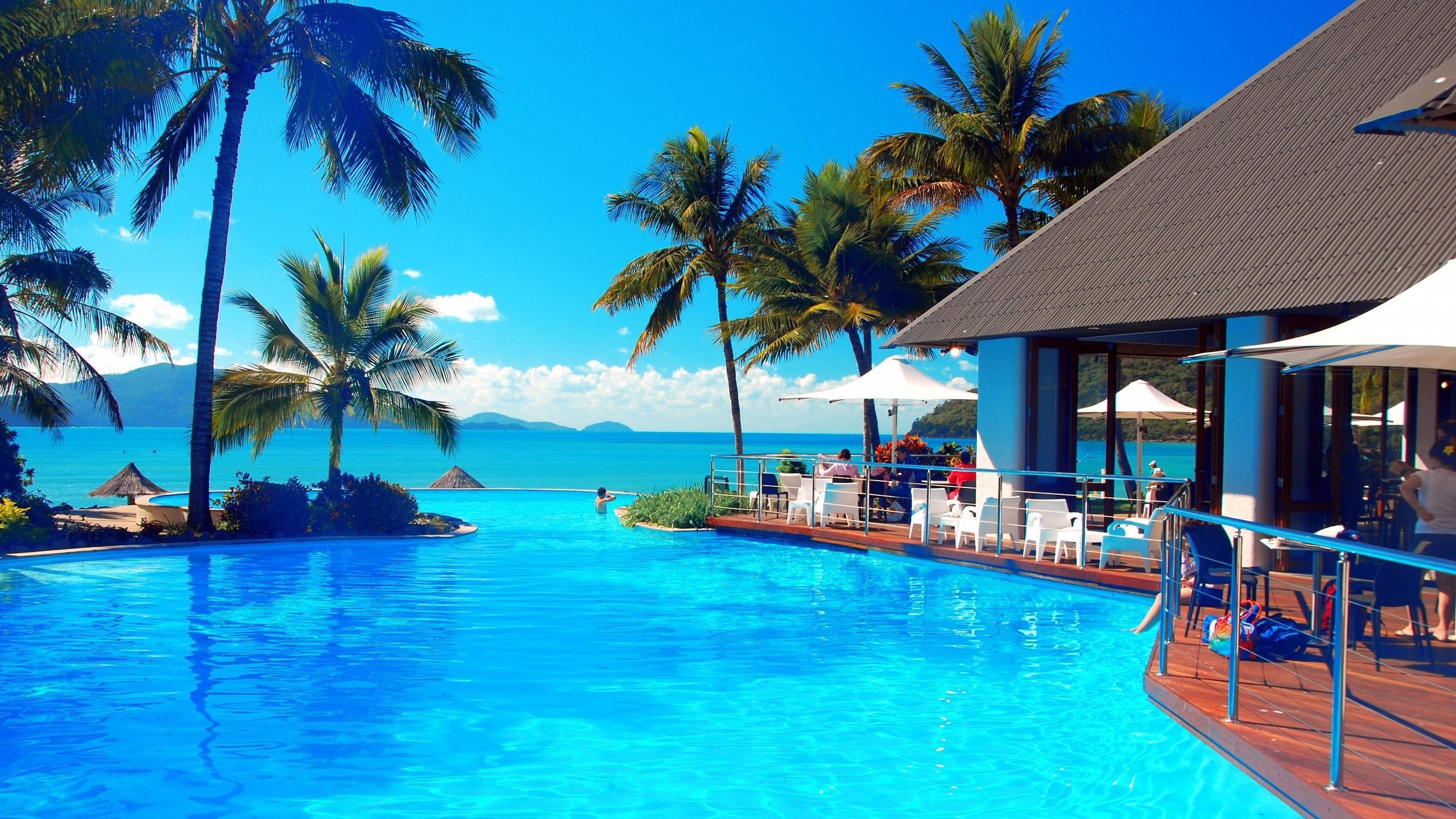 2560x1440 Beach Resort Swimming Pool With Beach Scenery View HD Beach Wallpaper