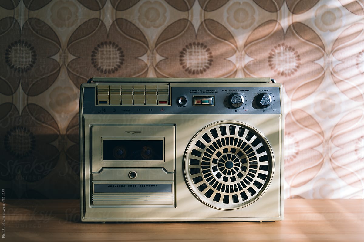 1200x800 Old cassette recorder against vintage wallpaper